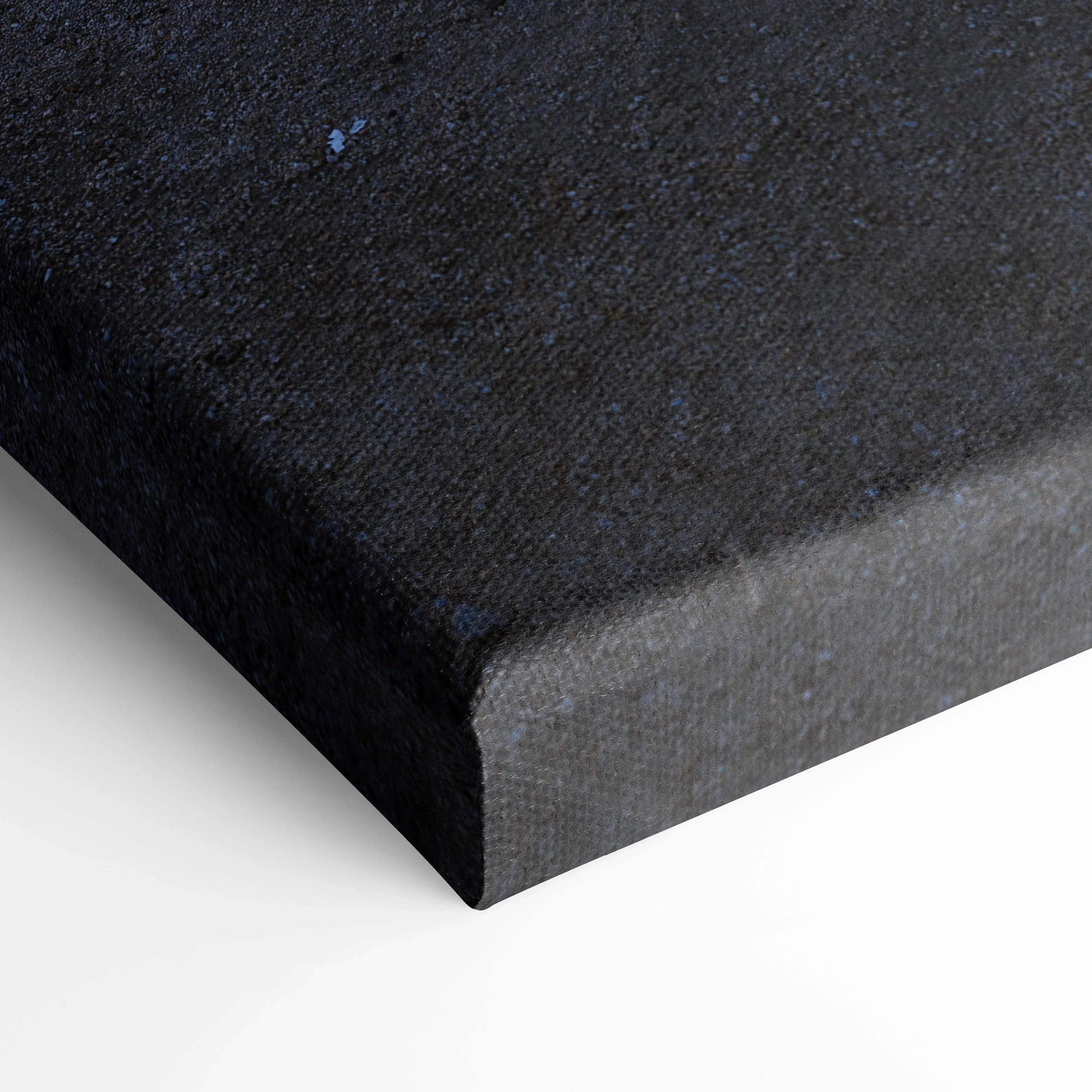 Close-up of textured black canvas corner with museum-quality stretch and clean edges, vertical wall art.