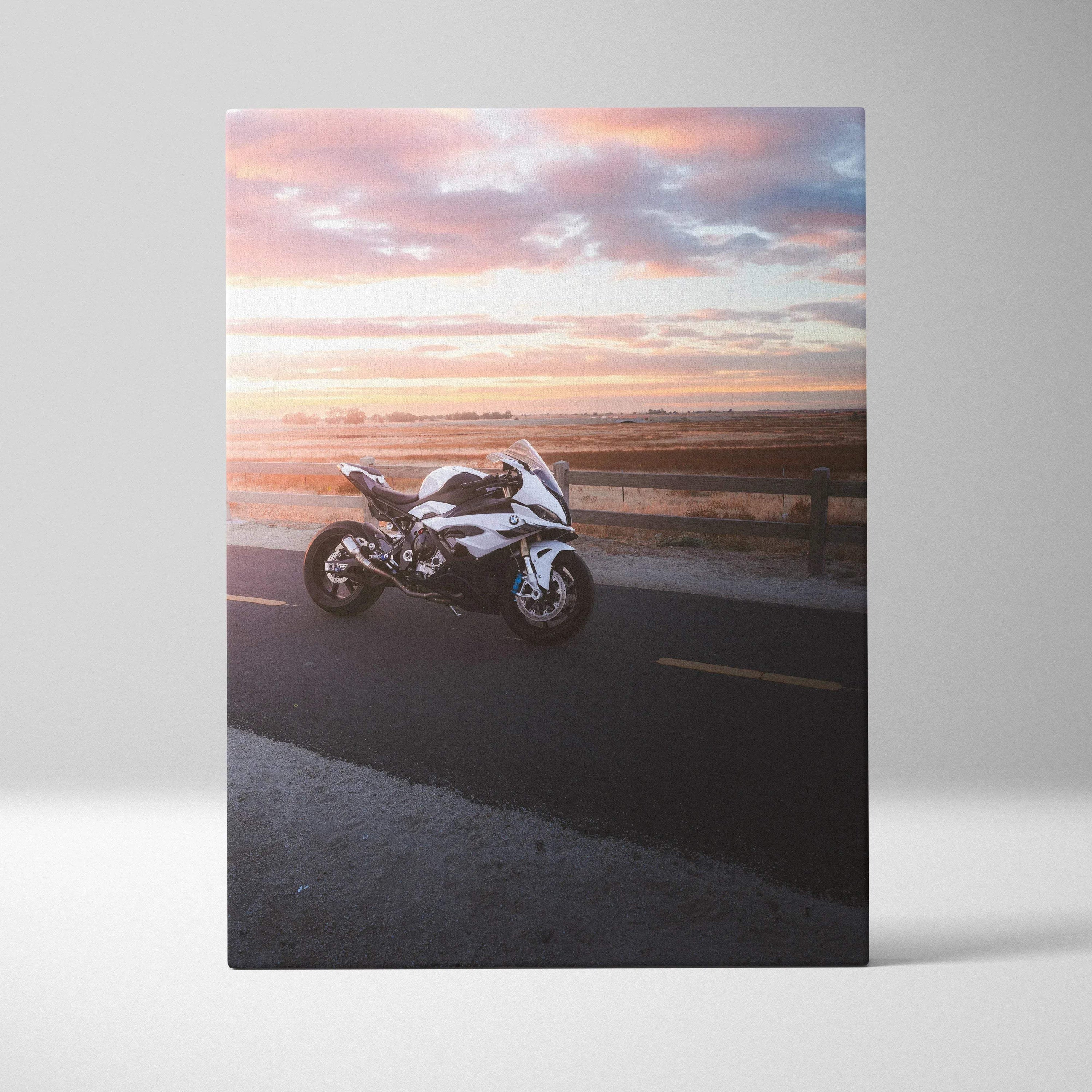 BMW S1000RR motorcycle on road at sunset canvas wall art with vibrant sky background.