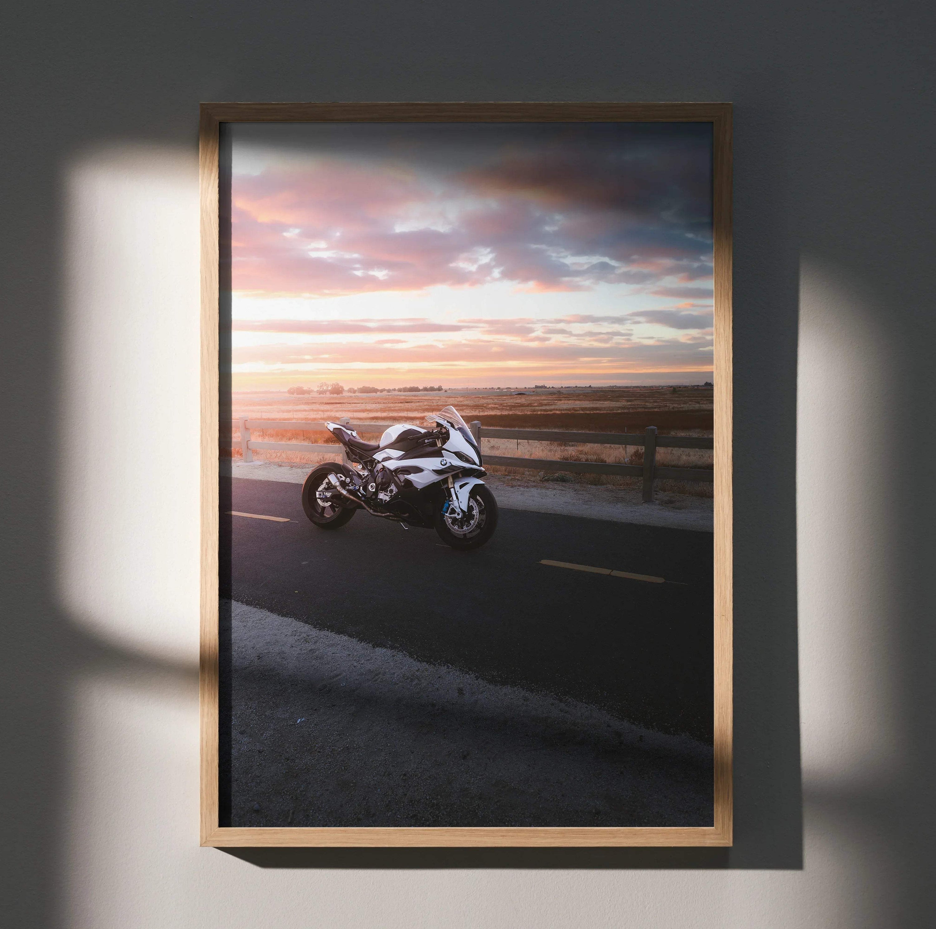 BMW S1000RR motorcycle wall art poster featuring sunset road scene in wood frame.