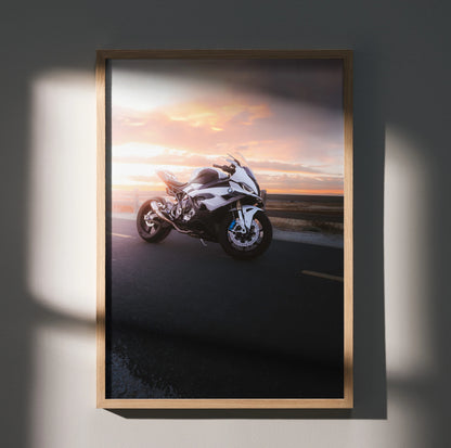 BMW S1000RR motorcycle poster with sunset background, sleek black and white sportbike wall art.
