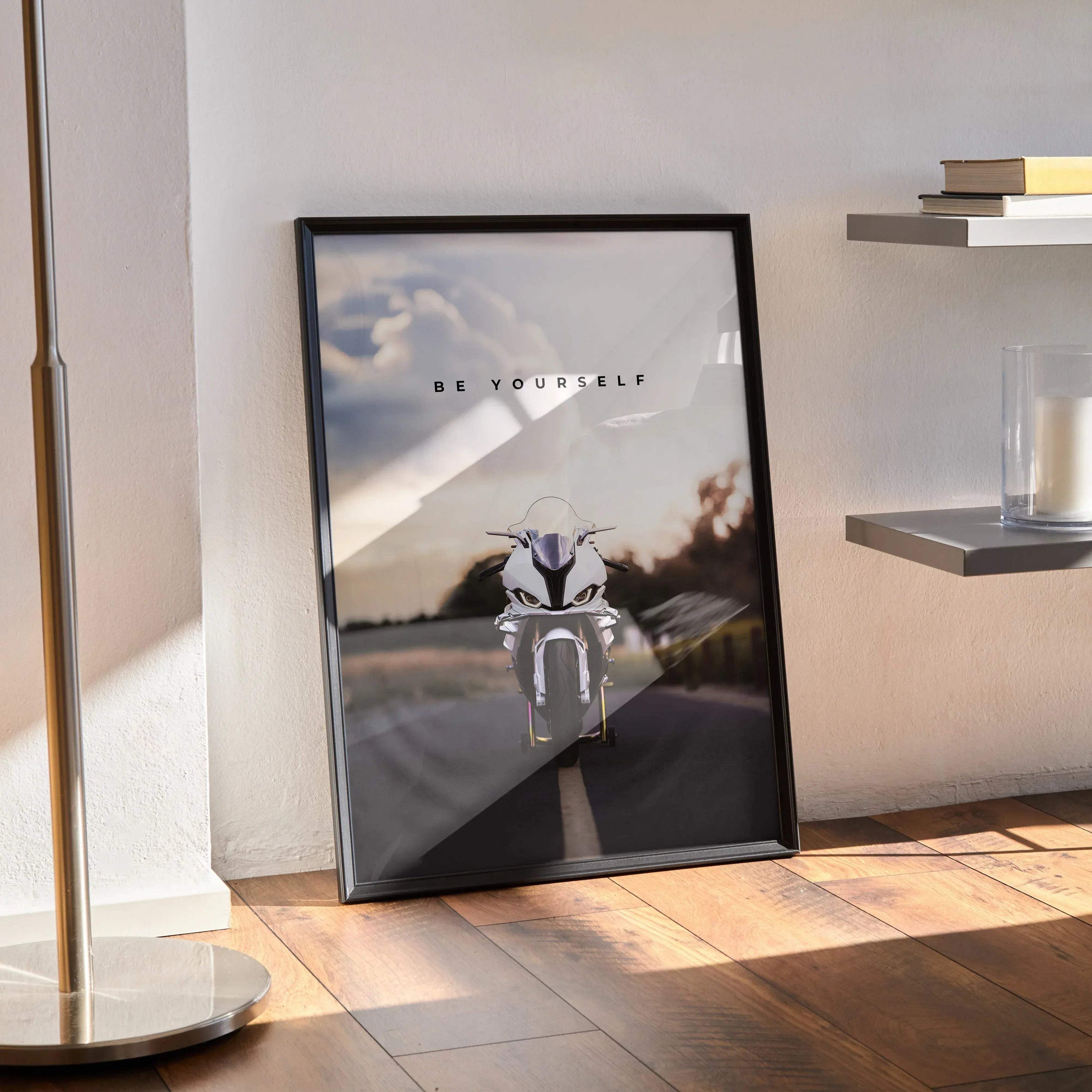 BMW S1000RR motorcycle poster with motivational text in black frame against wall, wall art design.