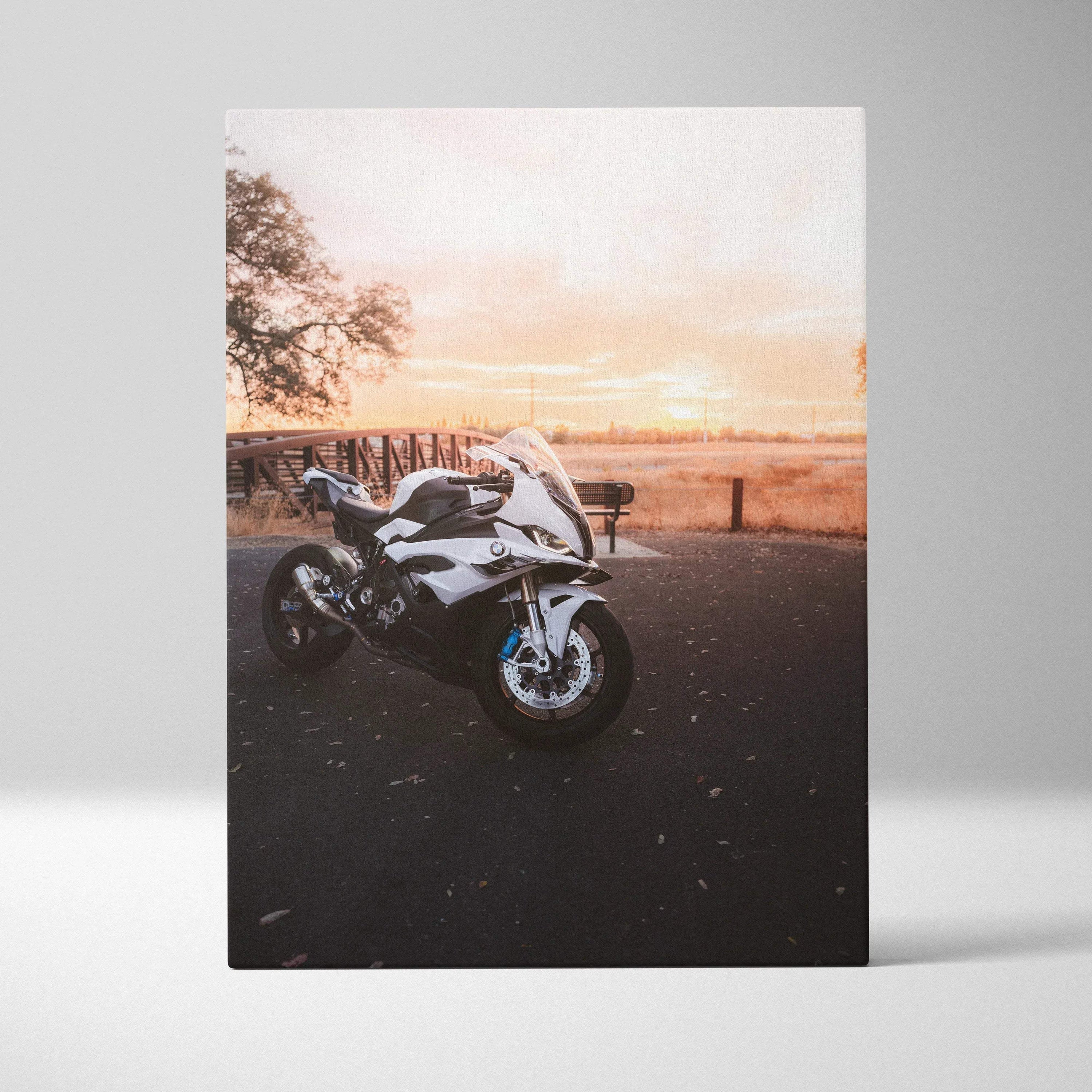 BMW S1000RR motorcycle at sunset printed on vertical canvas wall art with warm sky background.