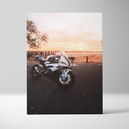BMW S1000RR motorcycle at sunset printed on vertical canvas wall art with warm sky background.
