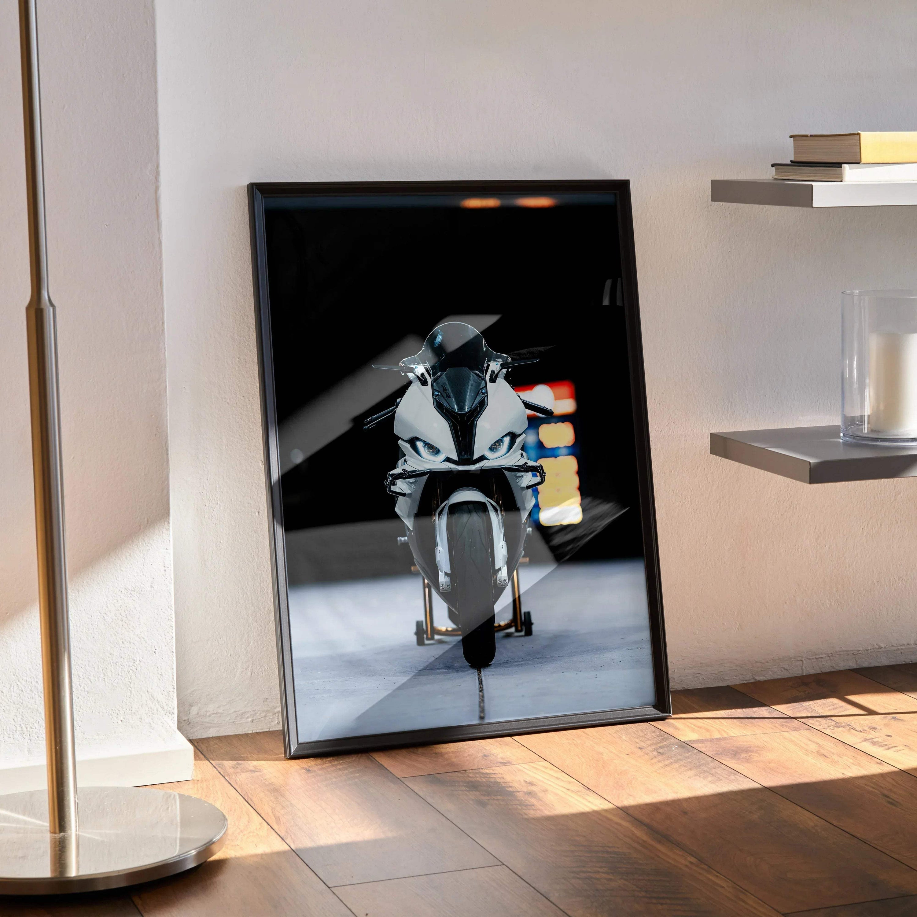 BMW S1000RR motorcycle poster wall art with sleek modern black frame on wooden floor.