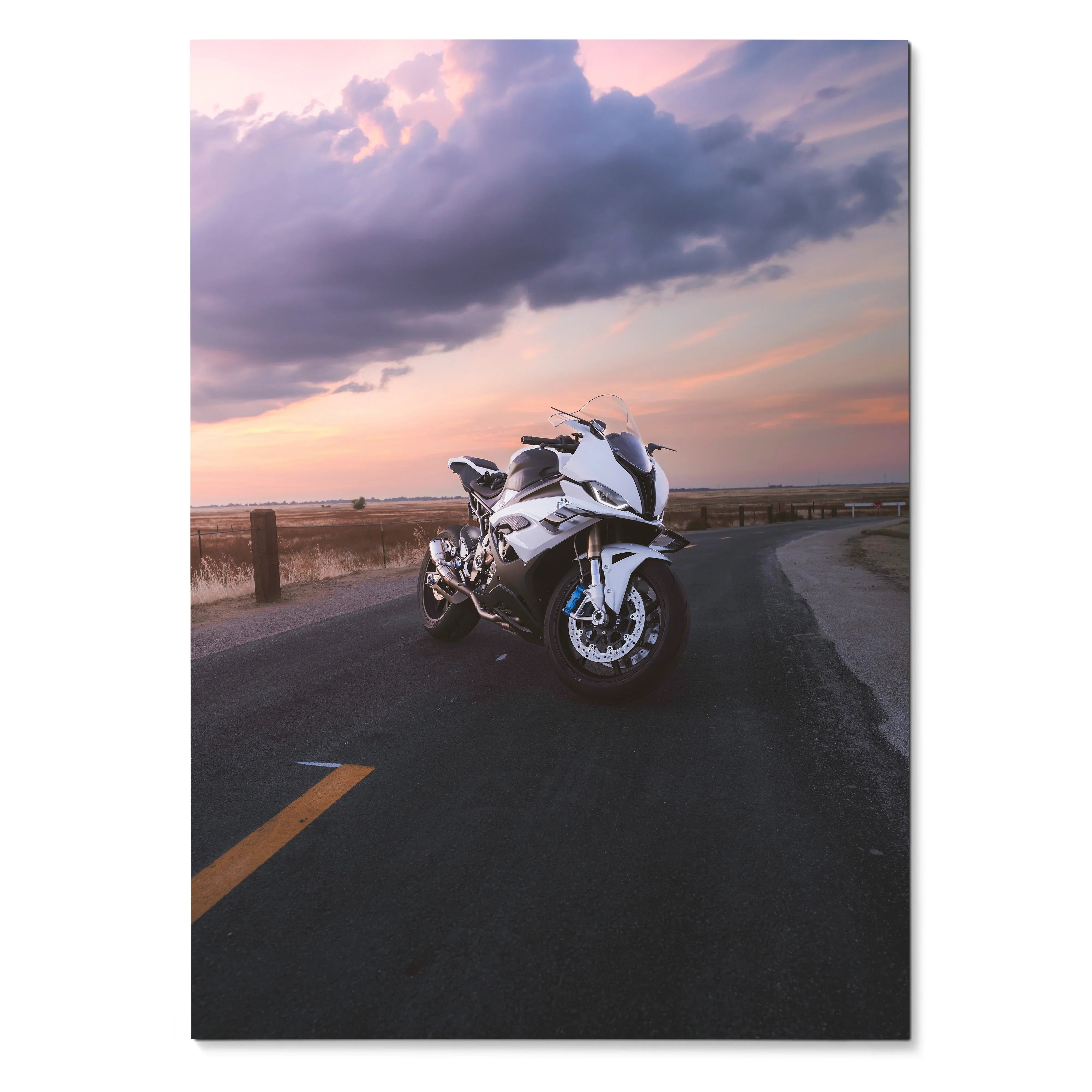 BMW S1000RR motorcycle on road at sunset poster wall art with dramatic sky background.