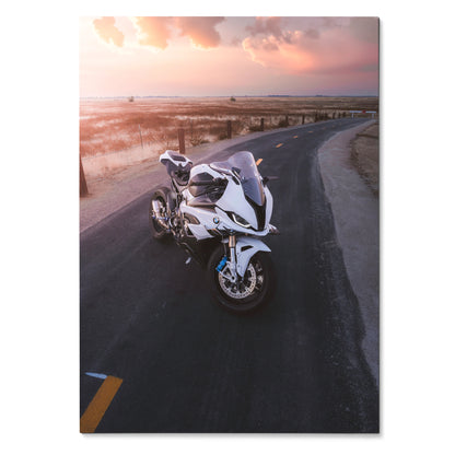 BMW S1000RR motorcycle on coastal road at sunset, poster wall art with vibrant sky colors.