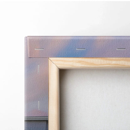 Close-up of the corner of a stretched canvas with visible wooden frame and staple details for wall art.