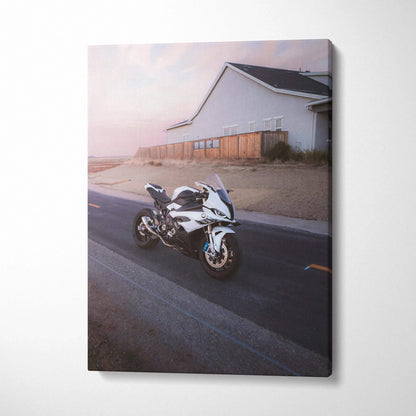 Vertical canvas art featuring a white BMW S1000RR motorcycle on a coastal road at dusk.
