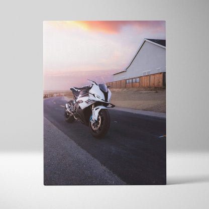 Vertical canvas wall art featuring a BMW S1000RR motorcycle on a road at sunset.