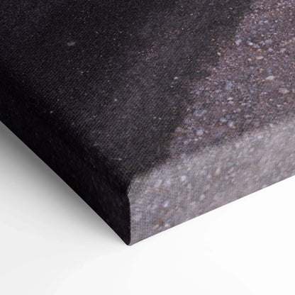 Close-up of textured black and gray canvas art edge with museum-quality finish and stretched wrap for wall art display.
