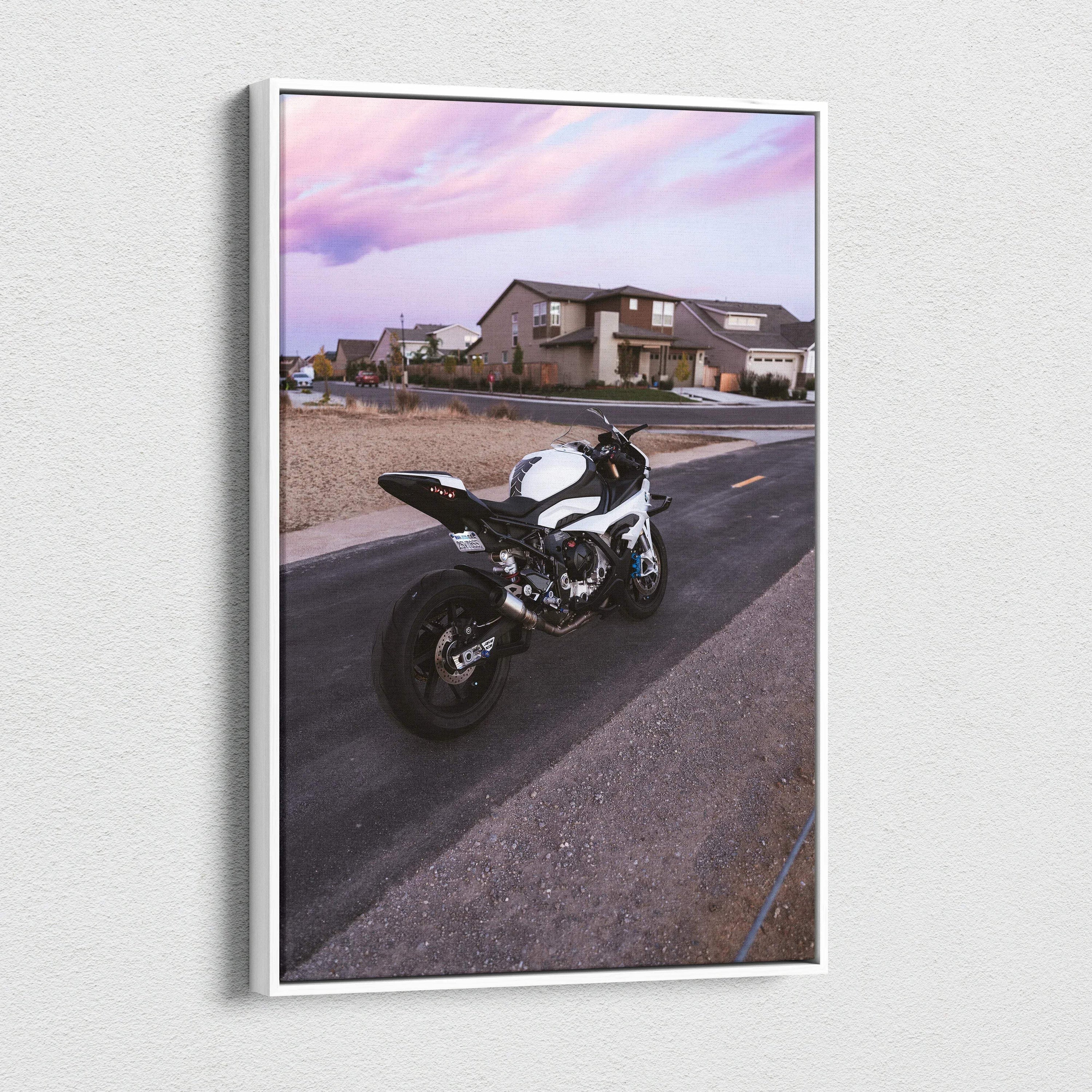 Vertical canvas wall art featuring a BMW S1000RR motorcycle on a suburban street under a pink sky.