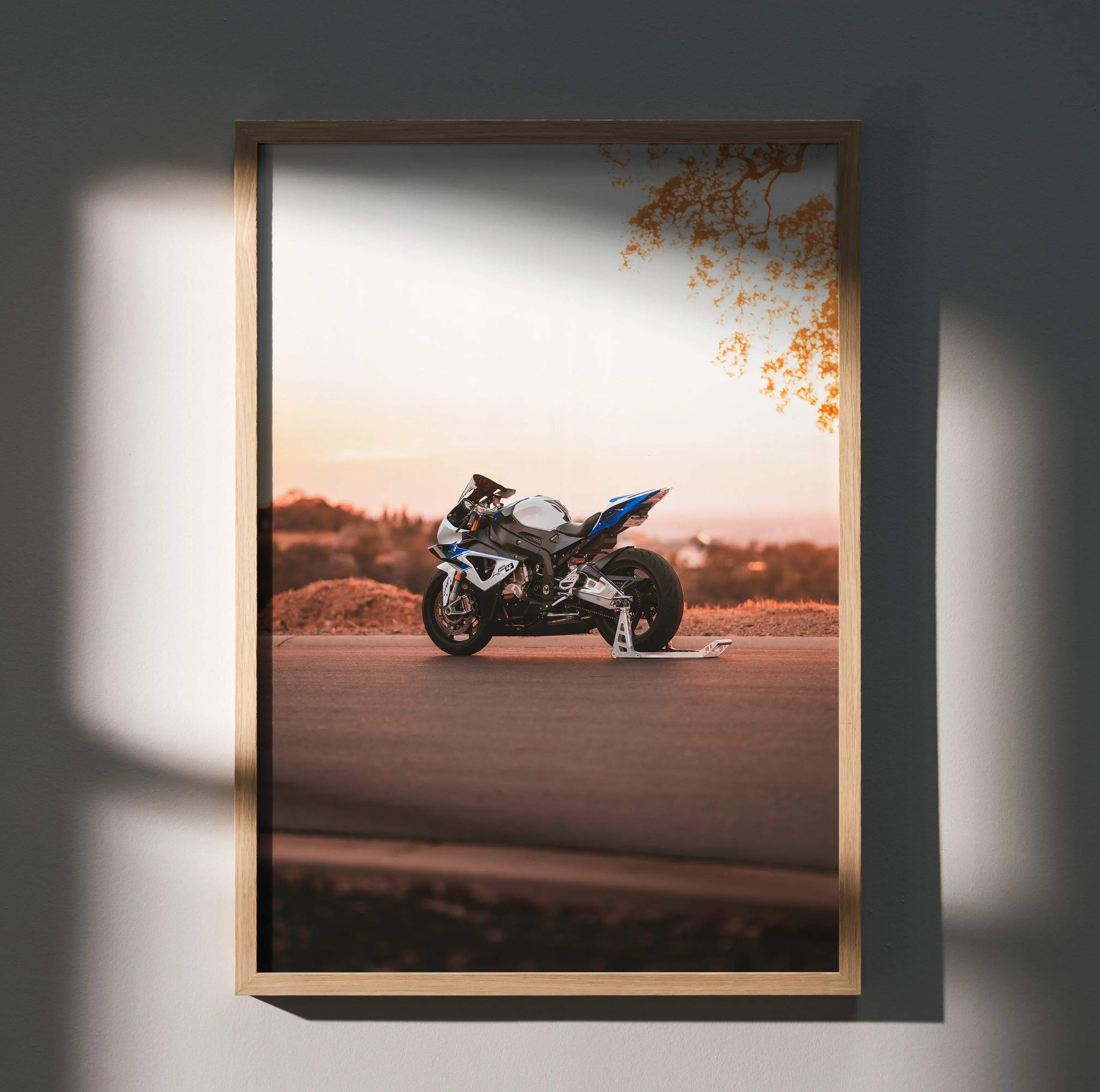 A framed photo print of a sleek blue and white BMW inspired S1000RR HP4 sport motorcycle at sunset on asphalt