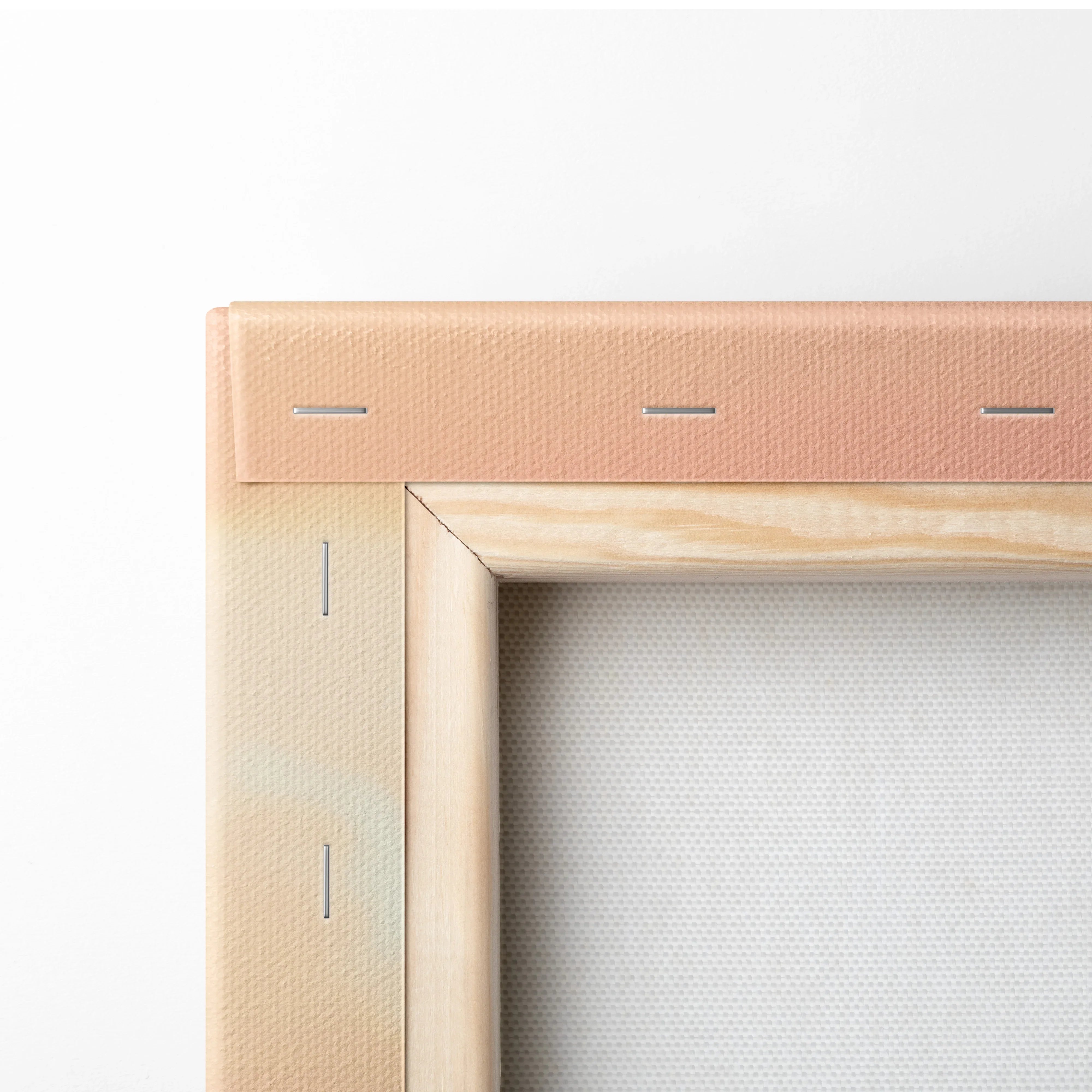 Close-up of wooden frame corner with beige canvas stretched and stapled for wall art canvas print.