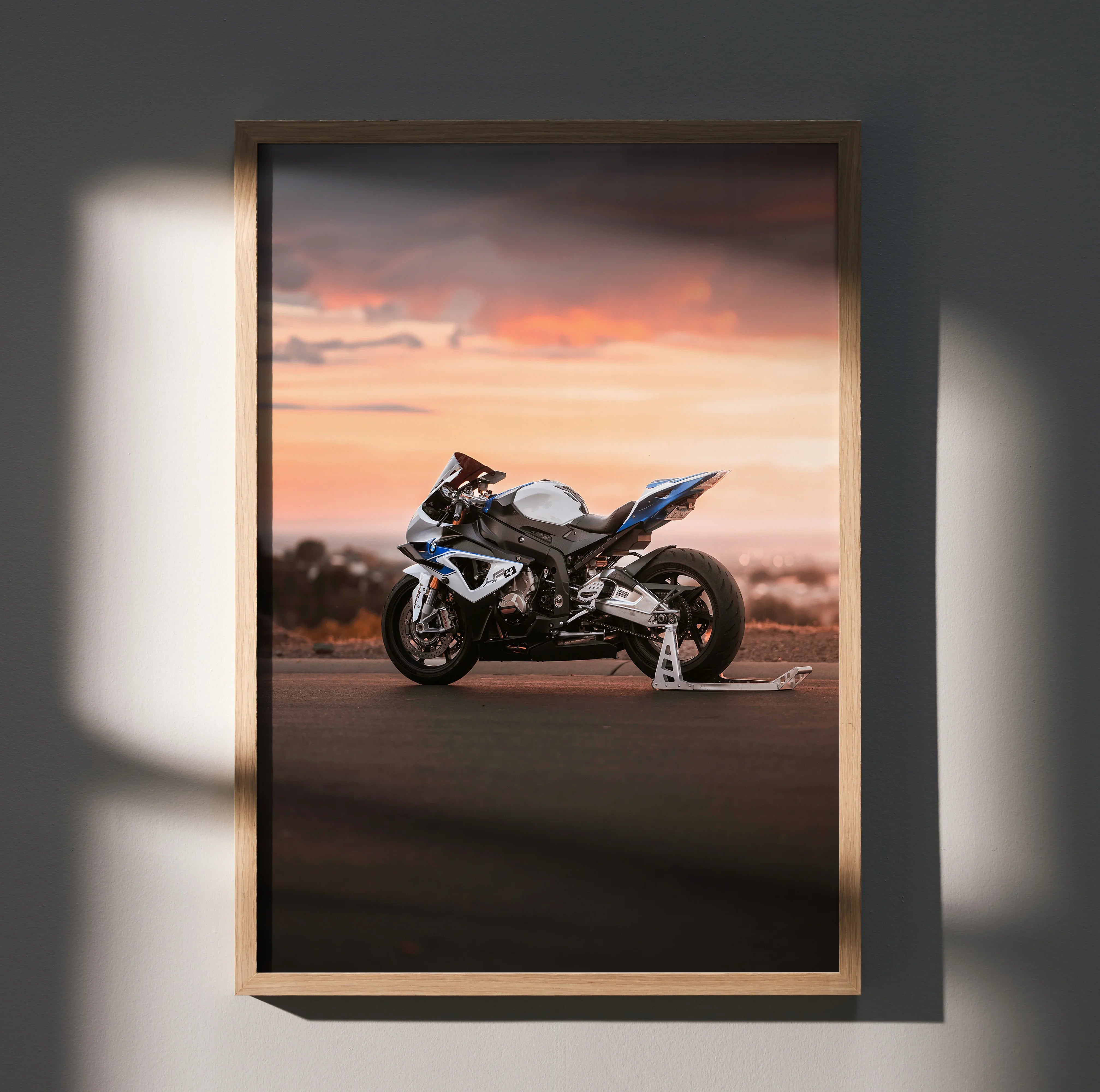 BMW S1000RR HP4 motorcycle poster with sunset backdrop, premium wall art in wooden frame.