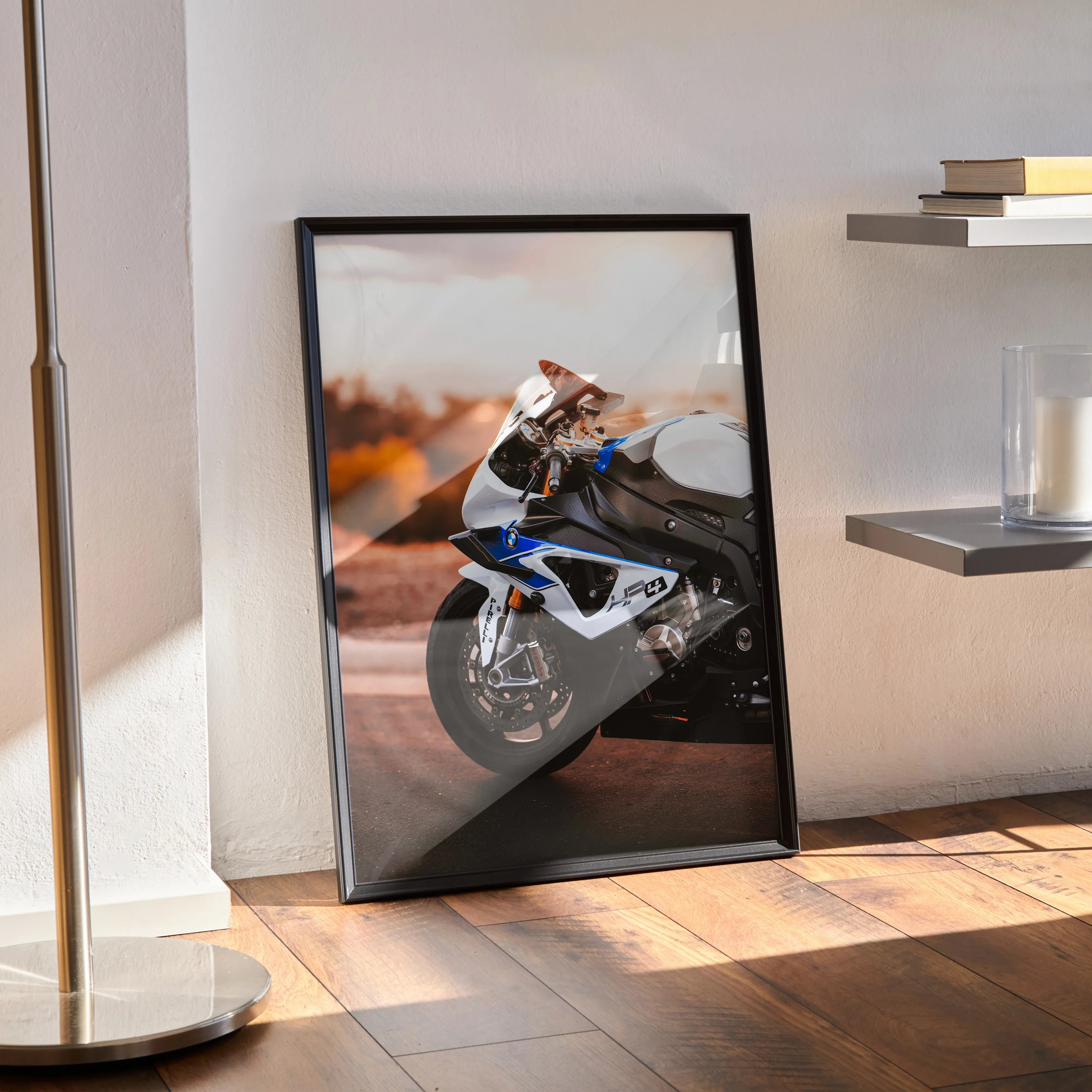 BMW S1000RR HP4 motorcycle poster wall art in black frame leaning against white wall on hardwood floor.