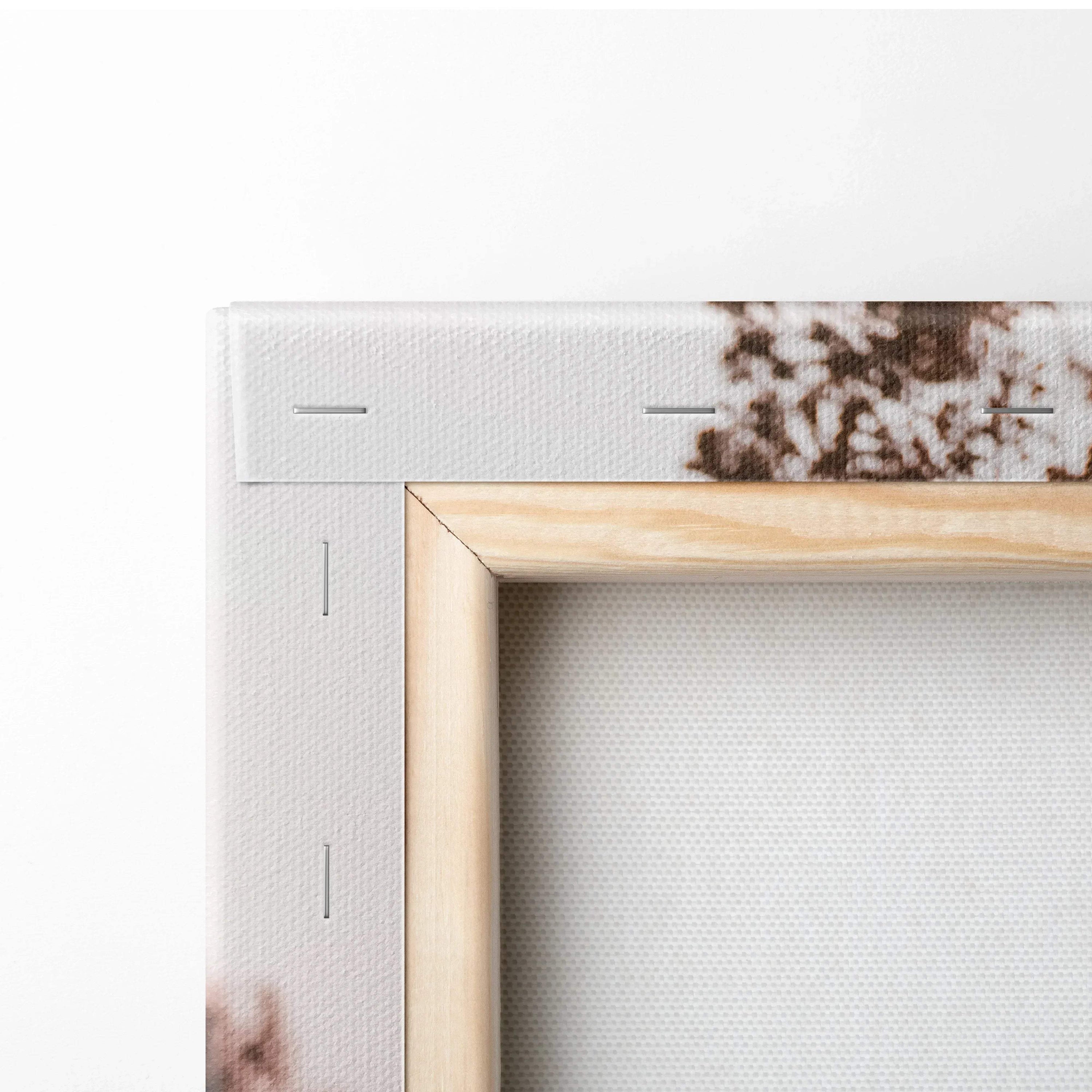 Close-up of corner detail on stretched canvas wall art with wooden frame and staples.
