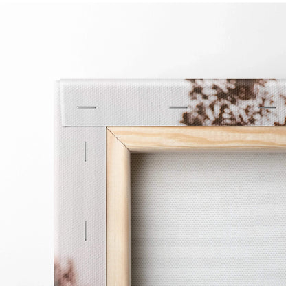 Close-up of corner detail on stretched canvas wall art with wooden frame and staples.