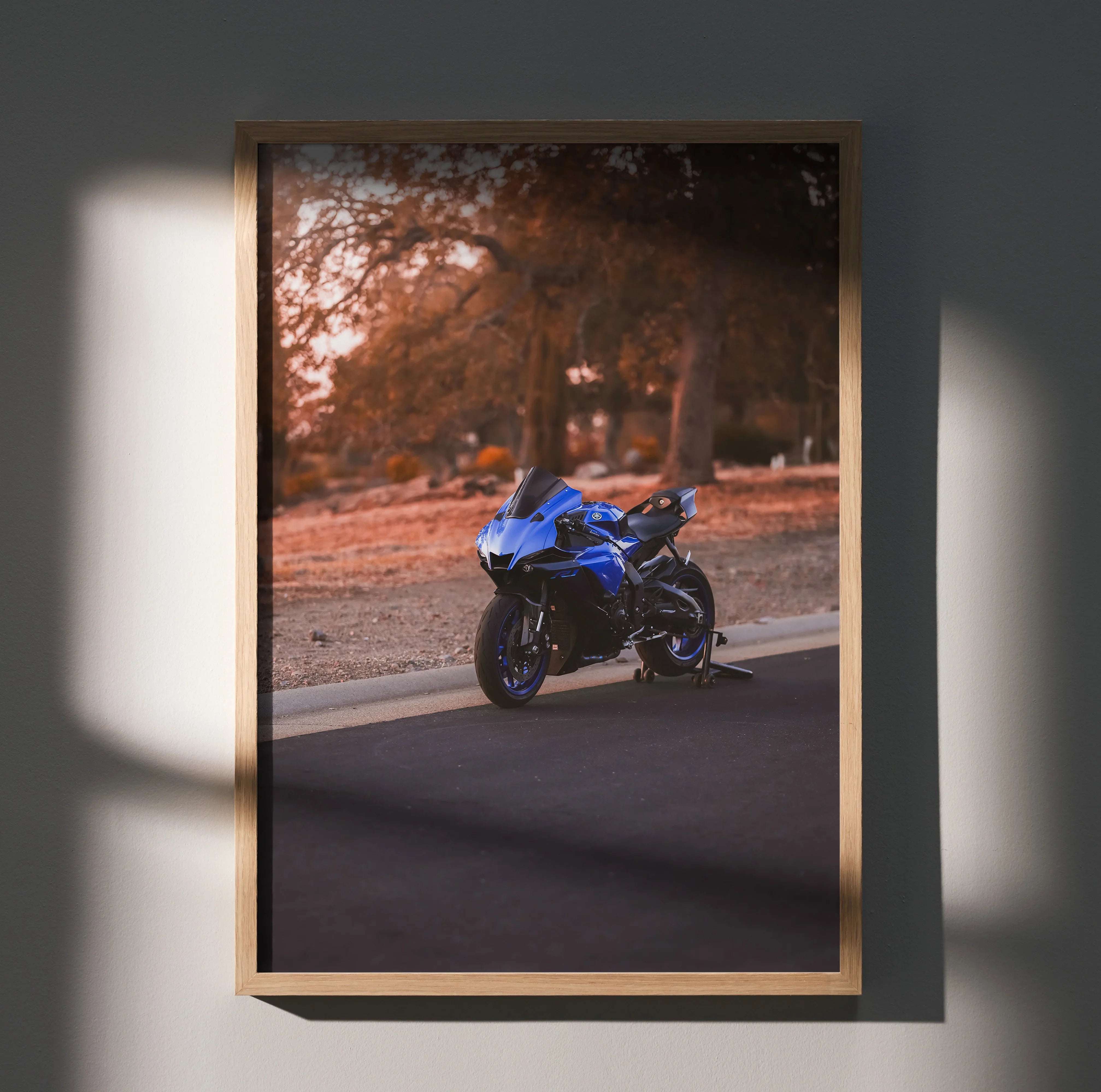 Yamaha R1 motorcycle poster with blue bike on road framed satin wall art in warm sunset tones.