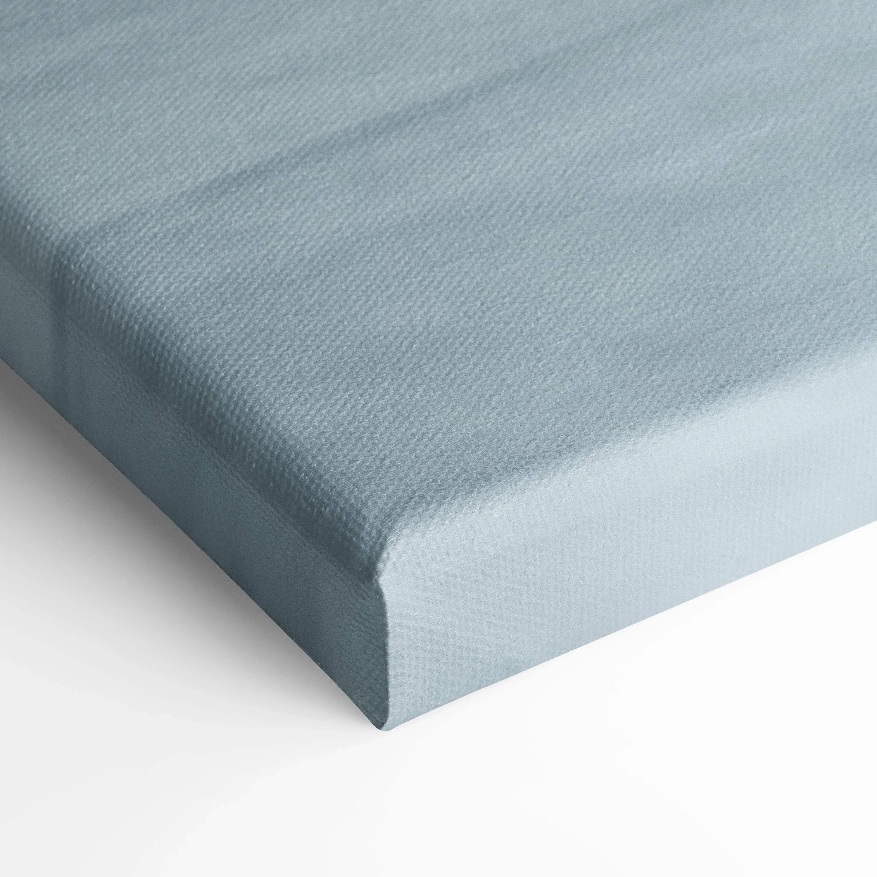 Close-up of light blue textured canvas corner, showcasing museum-quality wall art material and wrap.