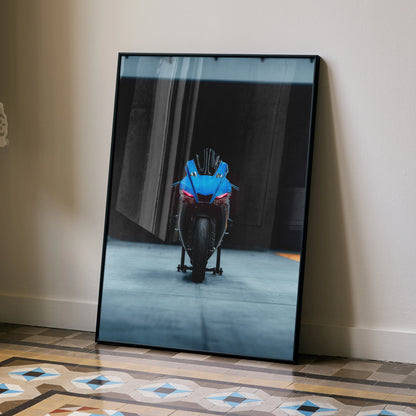 Framed Yamaha R1 motorcycle poster in blue and black leaning against a beige wall, modern wall art.