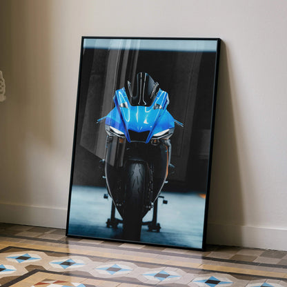 Yamaha YZF-R1 blue motorcycle poster leaning against wall, modern wall art with dark background.