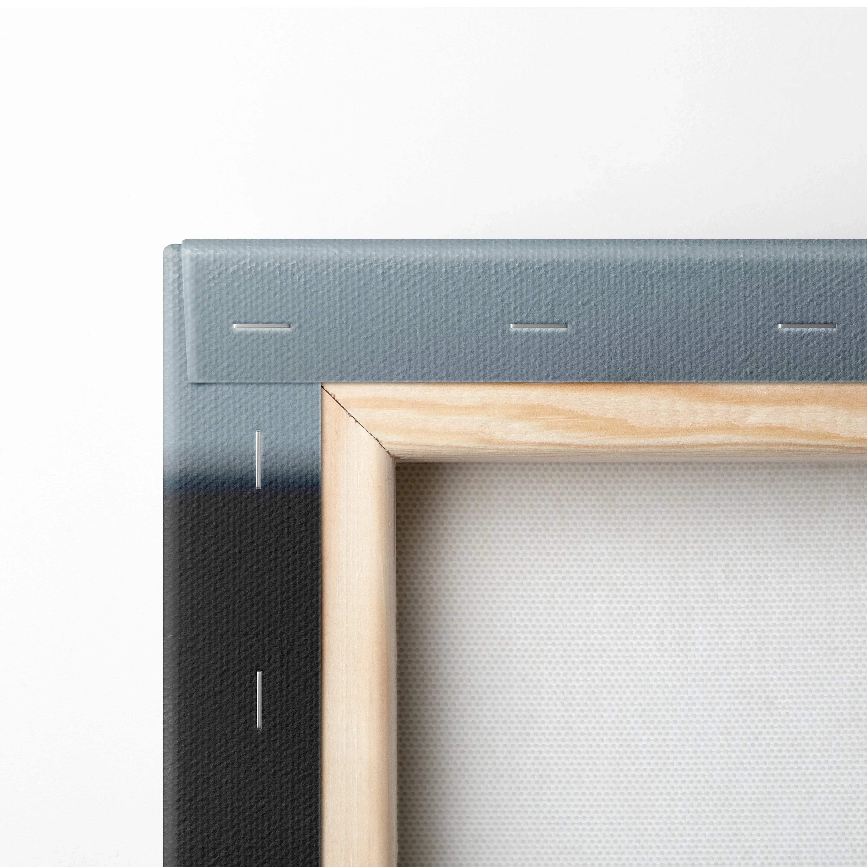 Close-up of stretched canvas wall art with natural wood frame and white fabric texture.