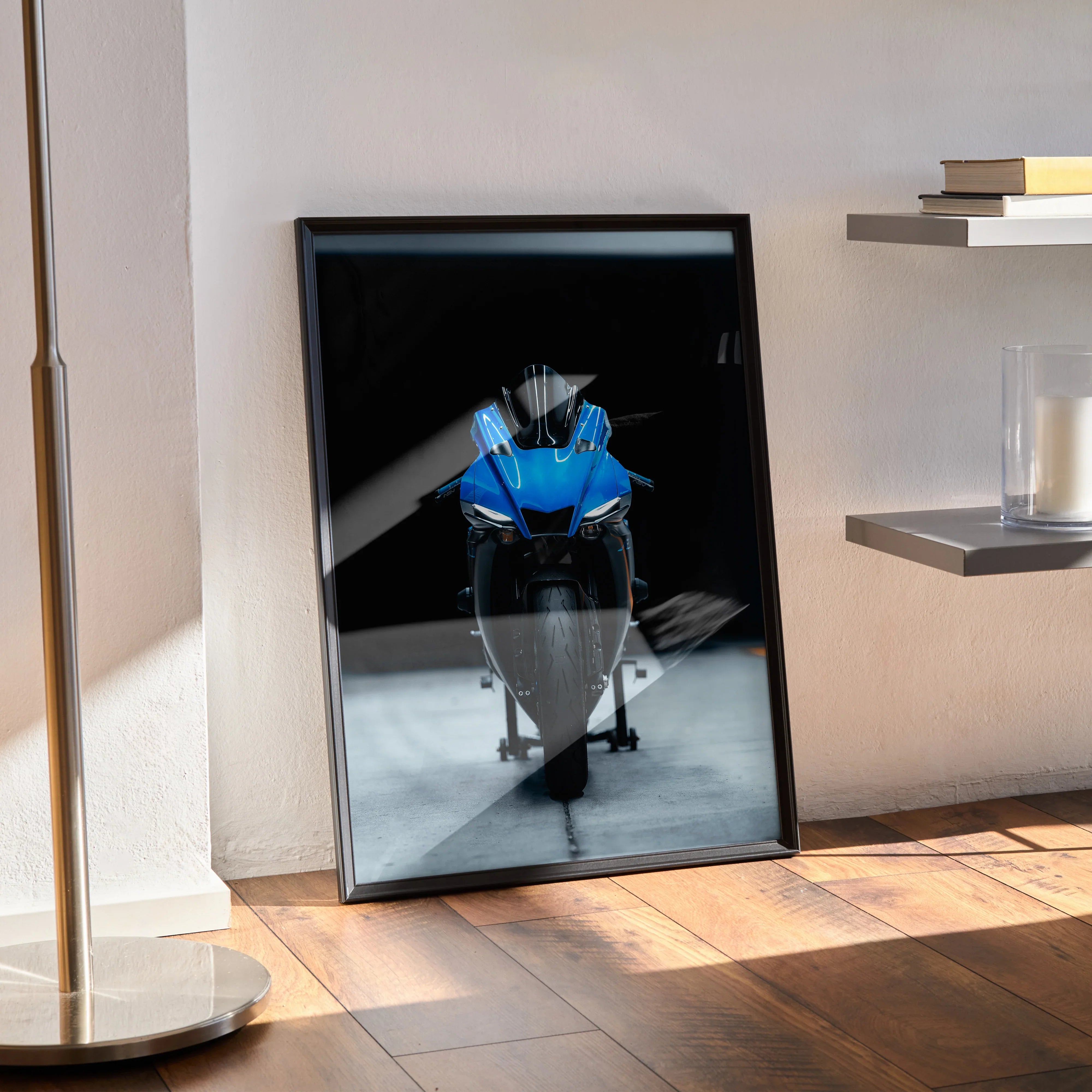 Yamaha R1 motorcycle poster in blue and white on black background, premium satin wall art framed and leaning on wooden floor.