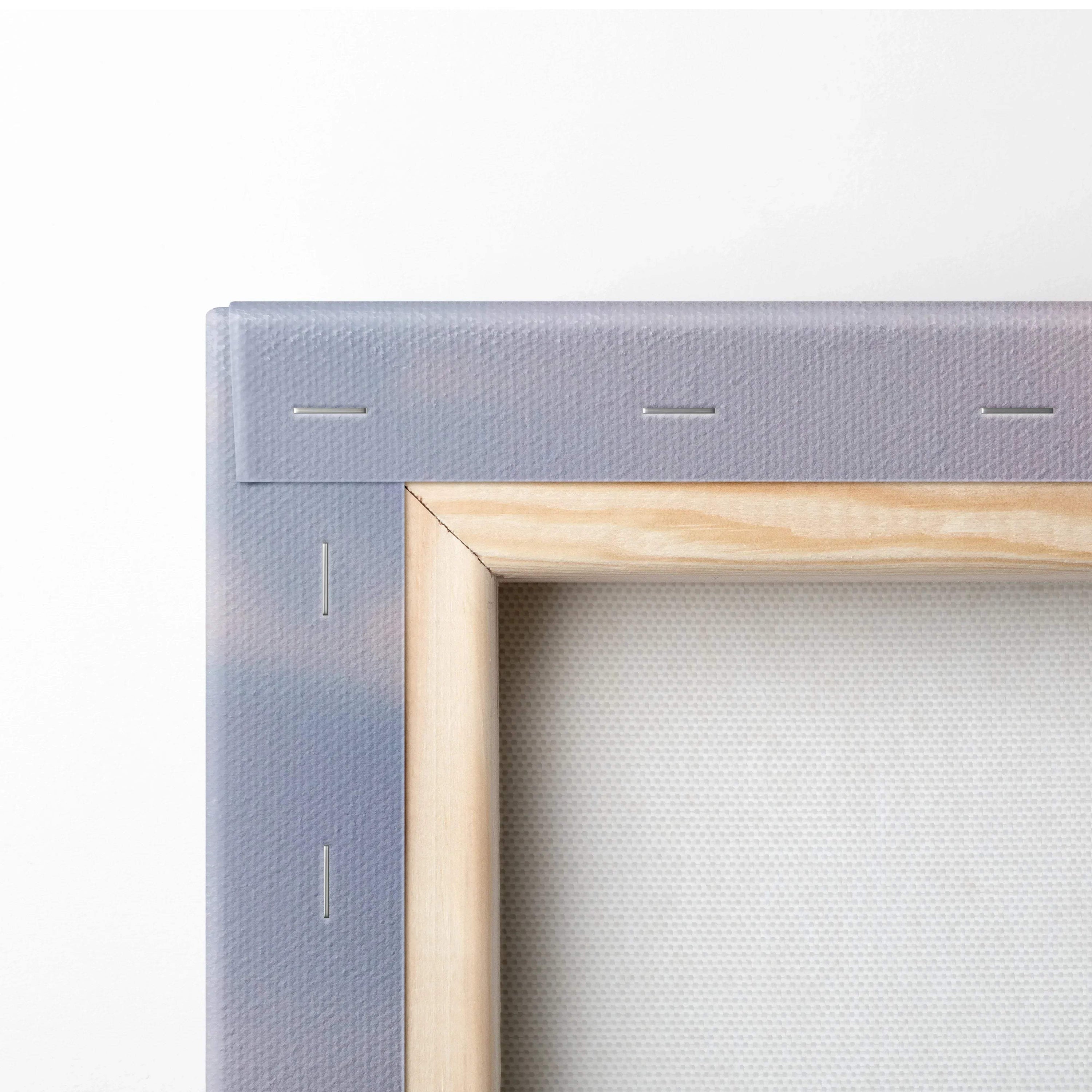 Close-up of stretched canvas corner with wooden frame and grey staples for wall art print.