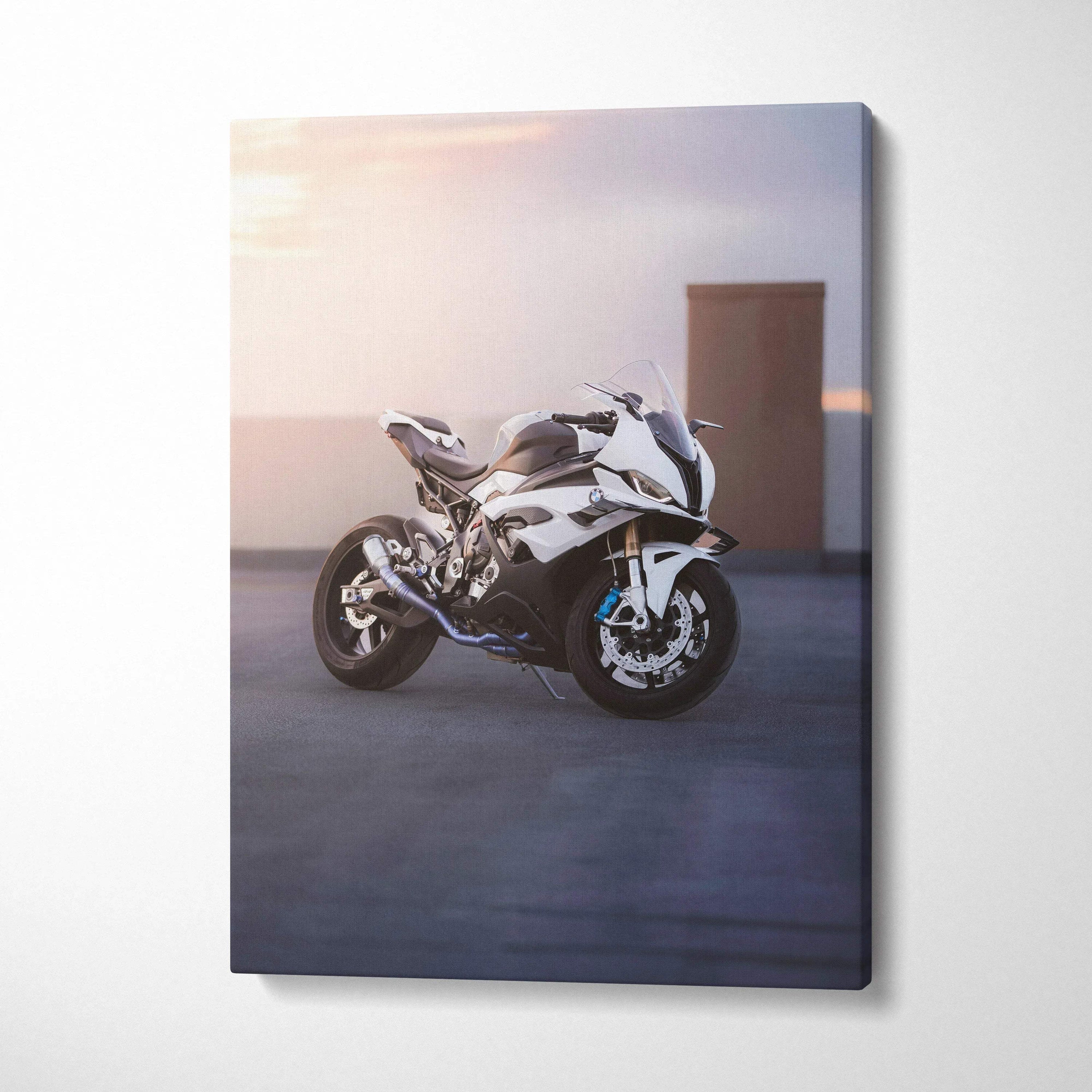 Vertical canvas wall art featuring a sleek white BMW S1000RR motorcycle at sunset with soft lighting.