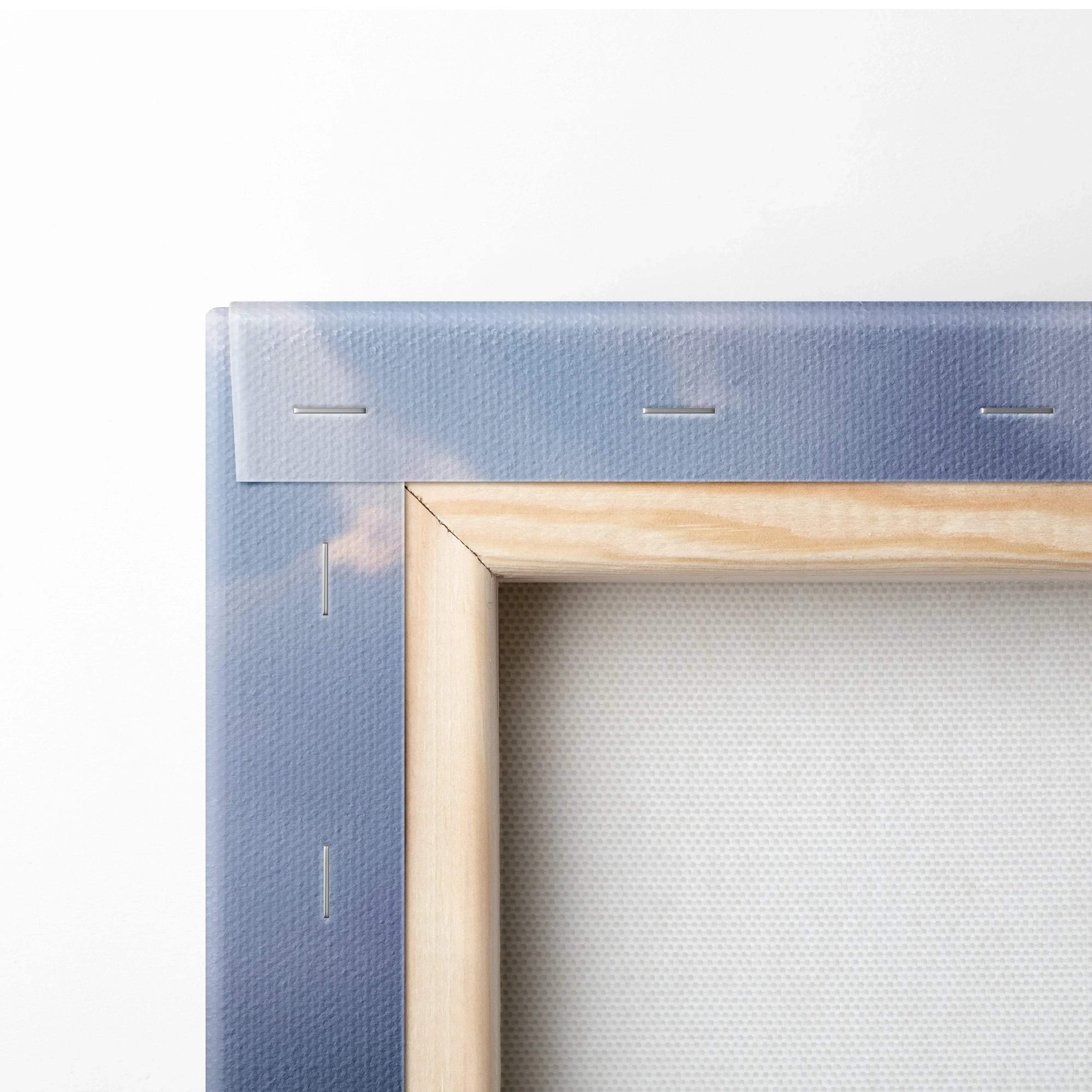 Close-up of wooden frame and stretched canvas edge showing detailed canvas texture and wall art construction.