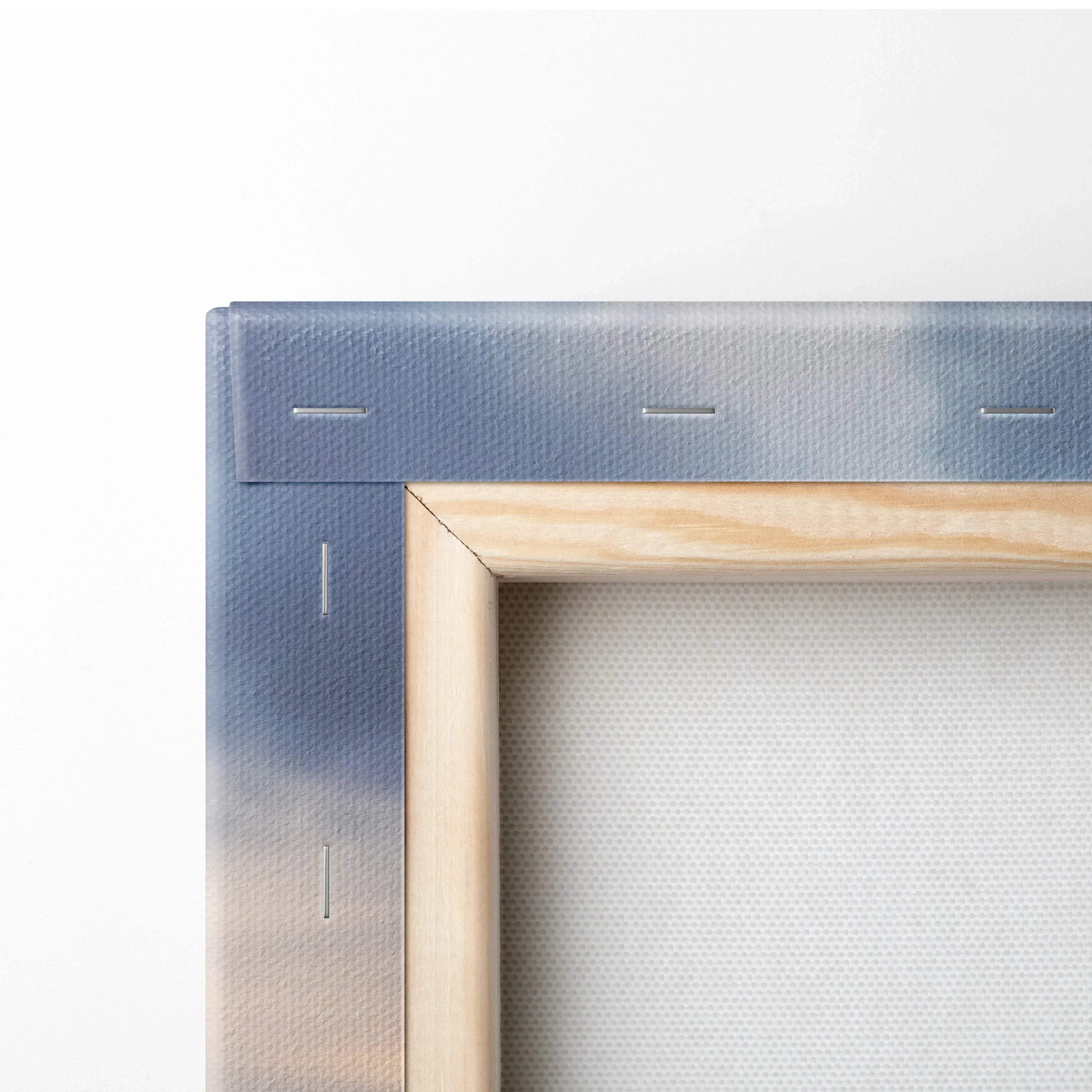 Close-up of wooden stretcher frame and stapled blue canvas back for vertical canvas wall art.