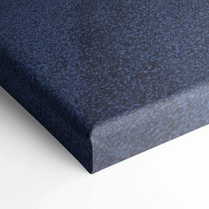 Close-up of textured dark blue canvas art wrapped around a vertical wooden frame for wall art display.