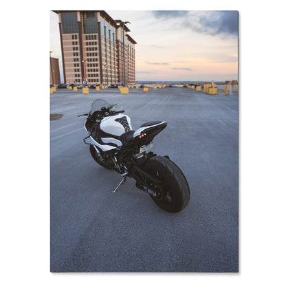 BMW S1000RR motorcycle parked on rooftop at sunset poster wall art in satin finish.