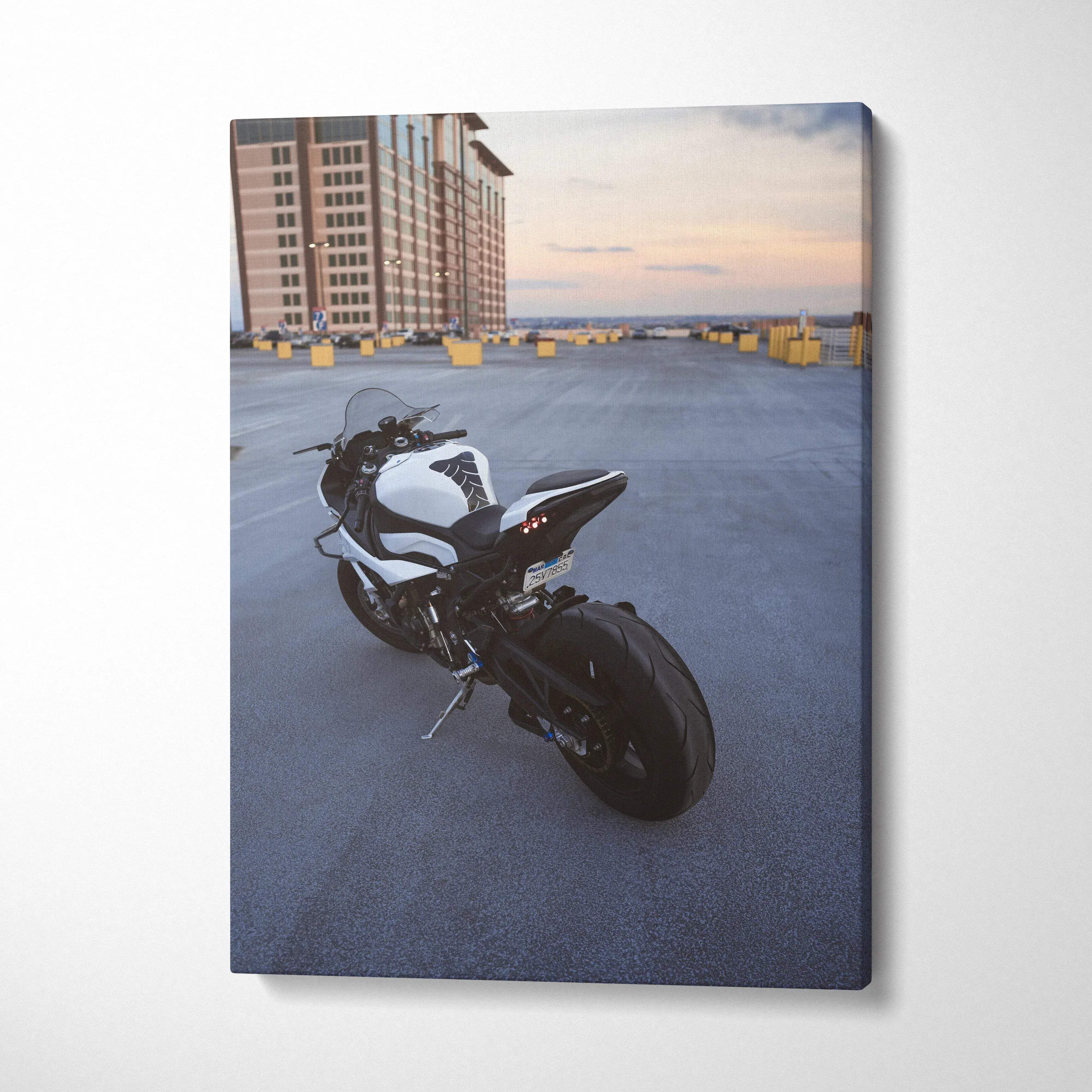 Canvas wall art featuring a black and white BMW S1000RR motorcycle on an urban rooftop at sunset.