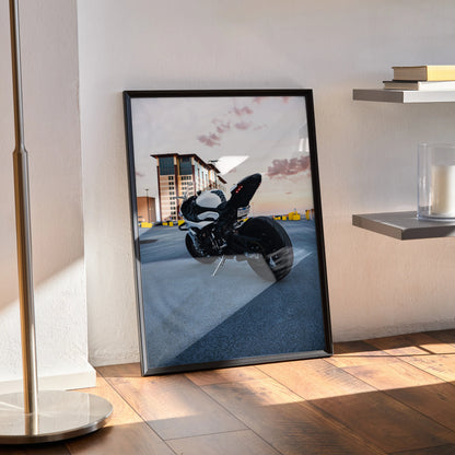 BMW S1000RR motorcycle poster leaning against wall, sunset sky, modern urban setting wall art.