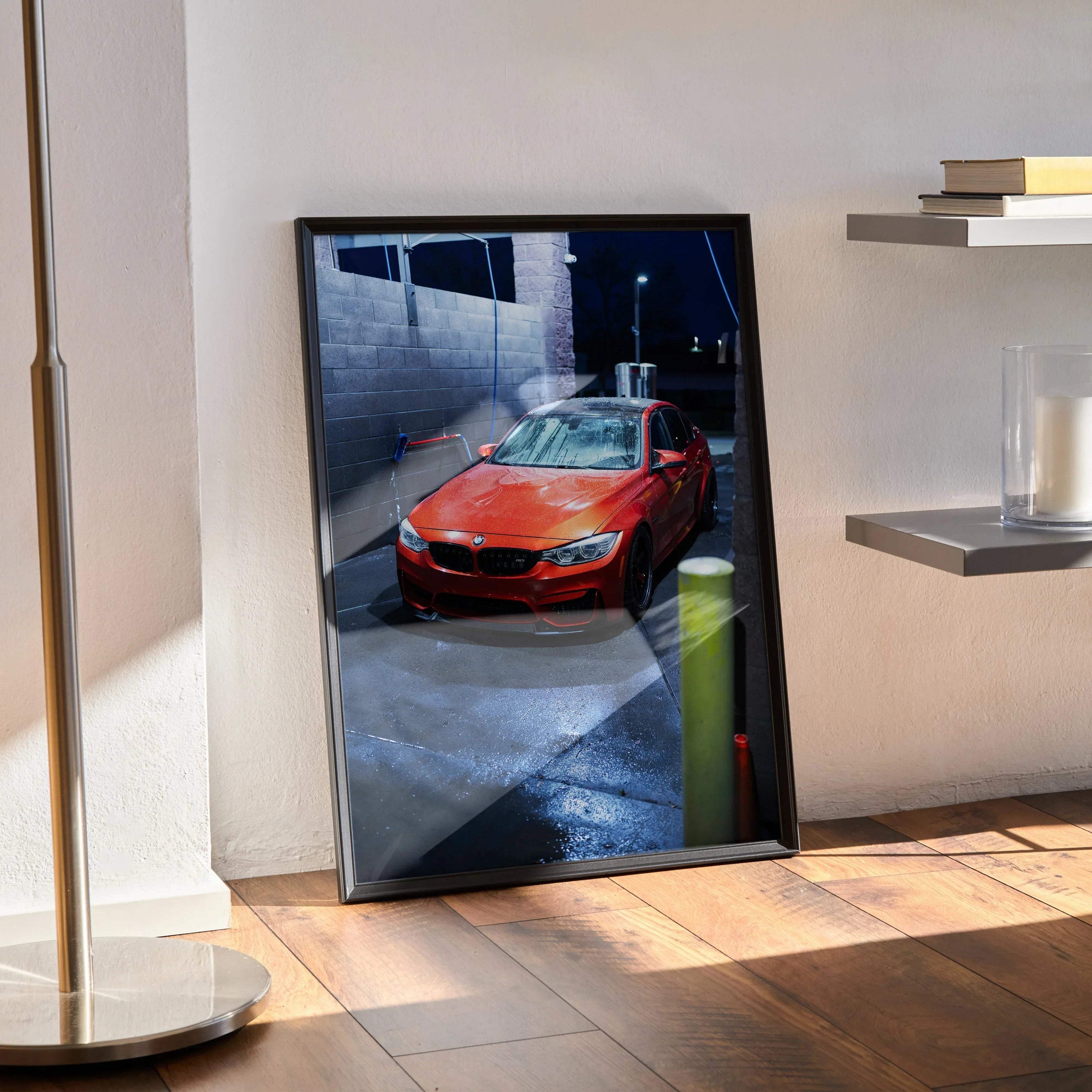 Red BMW F80 M3 poster with premium high-resolution automotive wall art in black frame leaning against wall.
