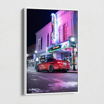 BMW F80 M3 red car parked in front of neon-lit theater at night, vertical canvas wall art.