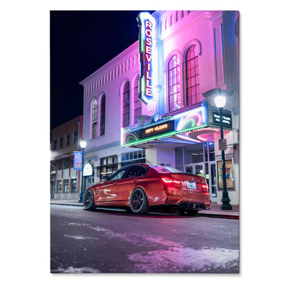 BMW F80 M3 poster featuring a red car parked by a neon-lit theater at night wall art.