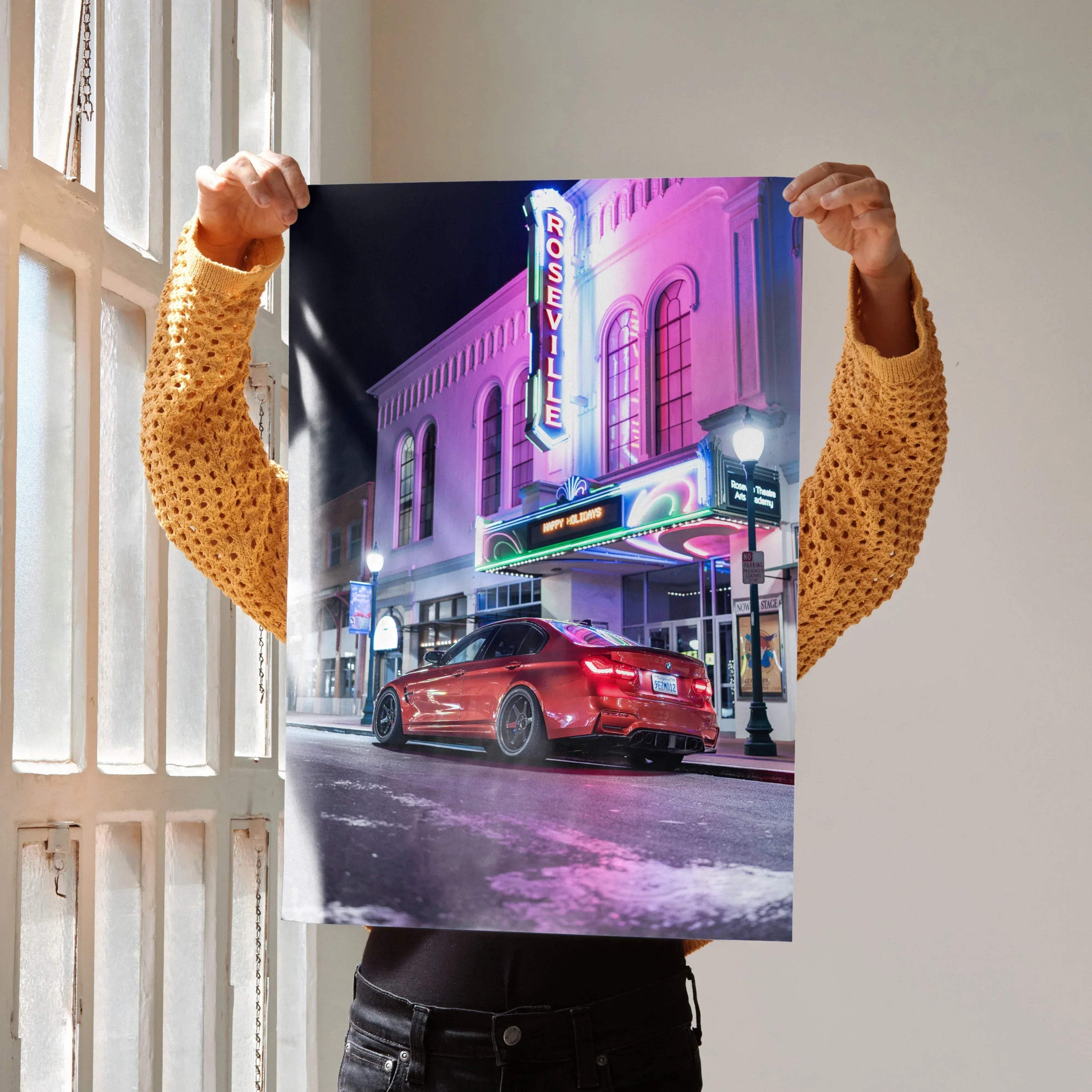 Poster featuring a red BMW F80 M3 in front of neon-lit urban building at night, automotive wall art.