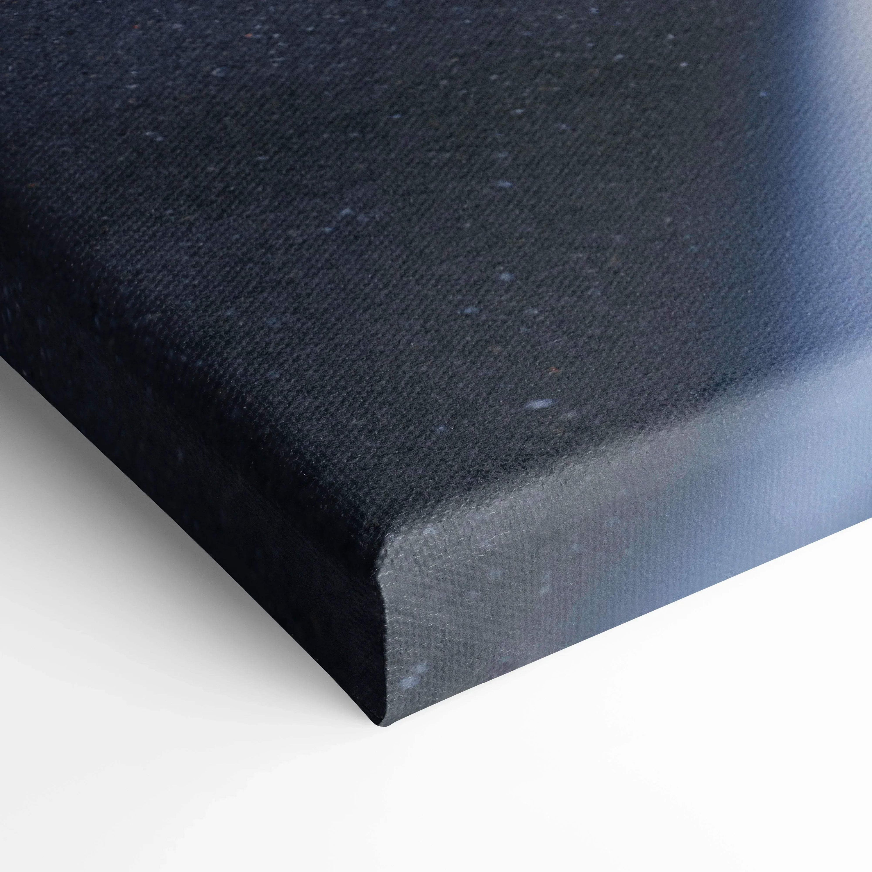 Black textured canvas corner on white background showcasing premium wall art canvas material.