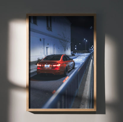 BMW F80 M3 driving at night with illuminated taillights poster wall art in wooden frame.