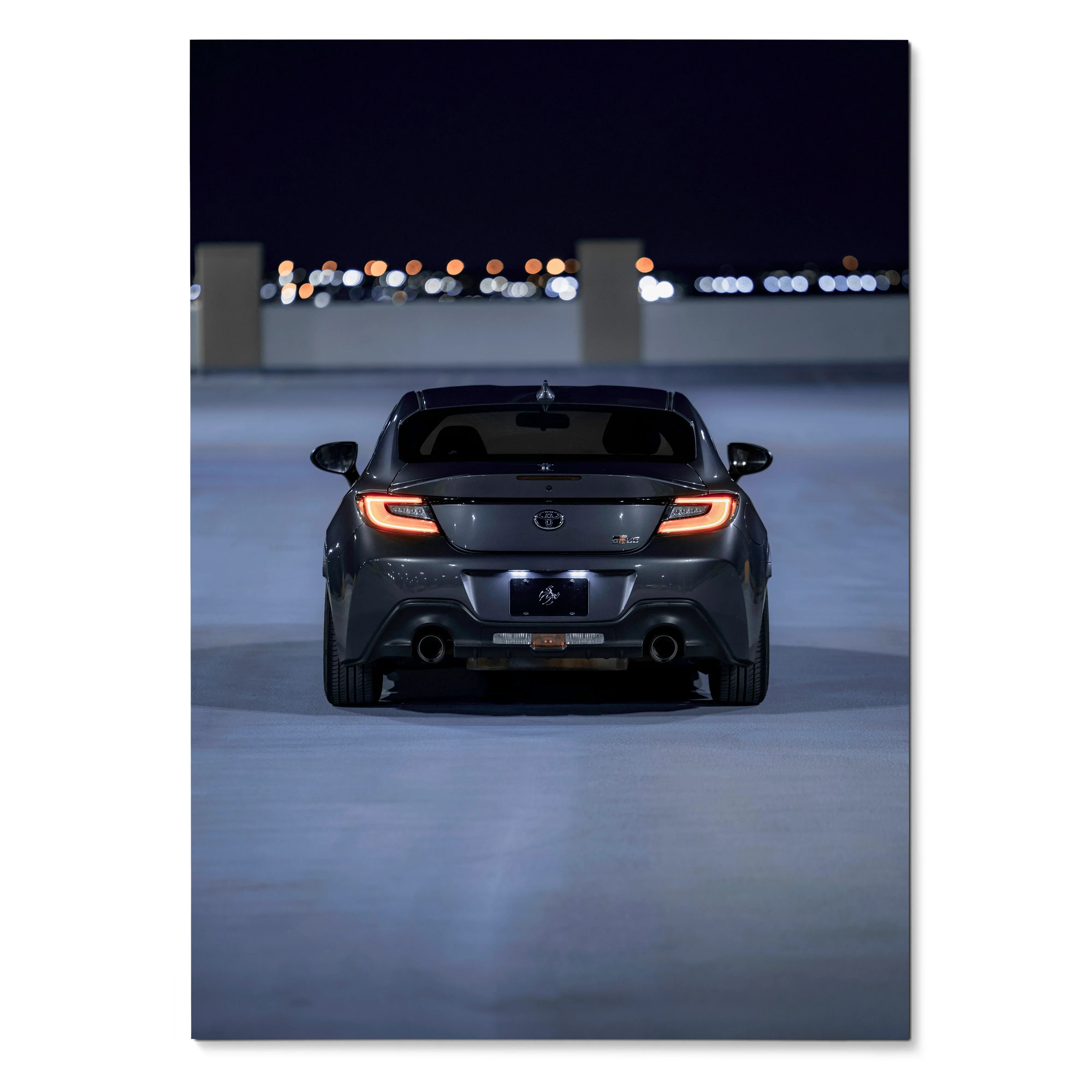 Toyota GR86 rear view poster with illuminated taillights and dark background wall art.