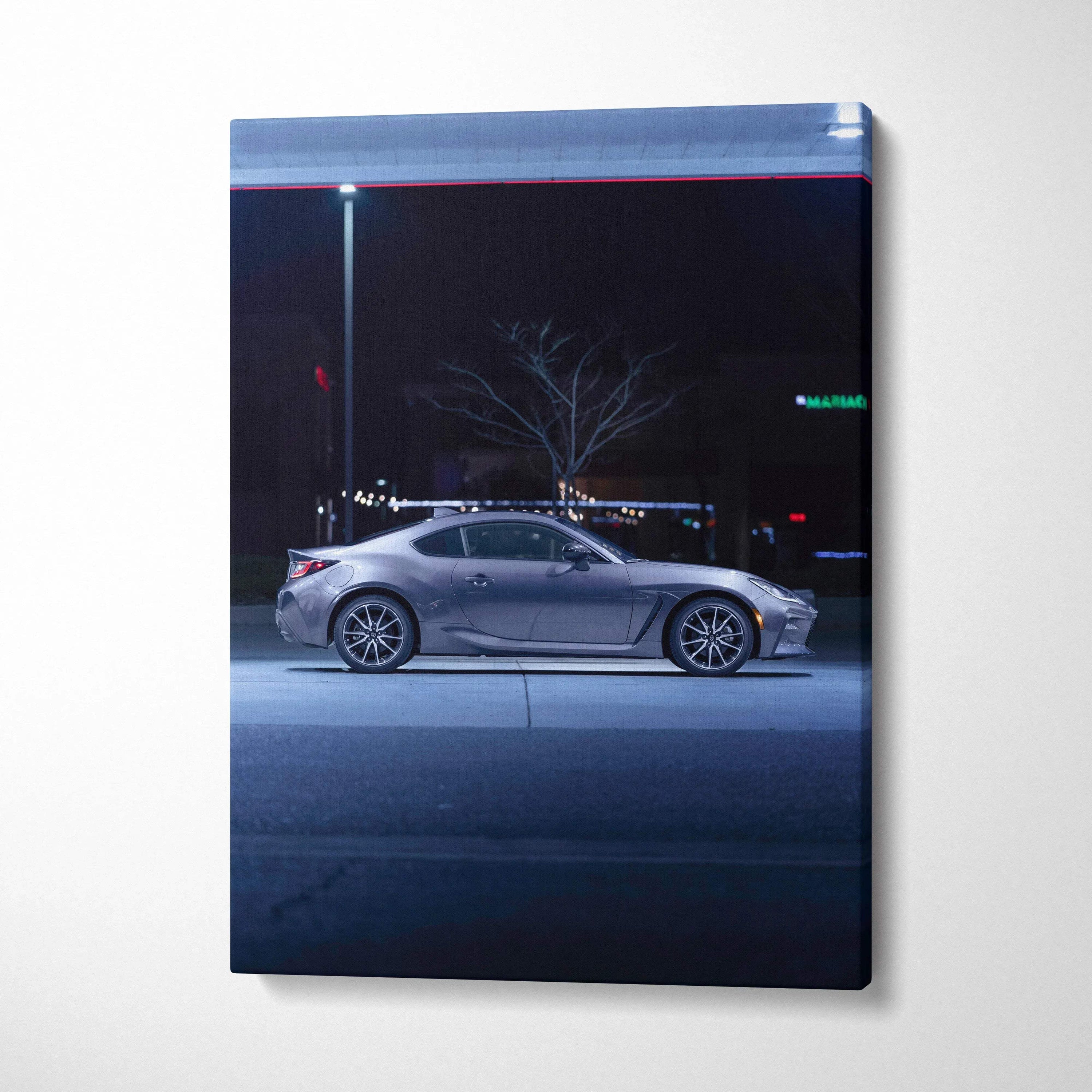 Toyota GR86 silver sports car at night canvas wall art with dark urban background.