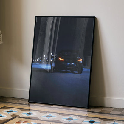 Toyota GR86 illuminated headlights night scene poster wall art leaning on floor.