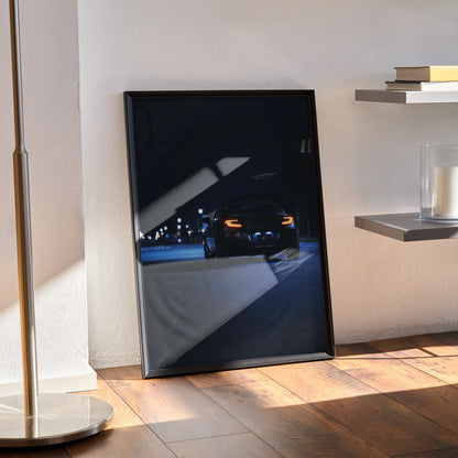 Toyota GR86 art poster leaning against wall with dark, moody car night scene wall art.