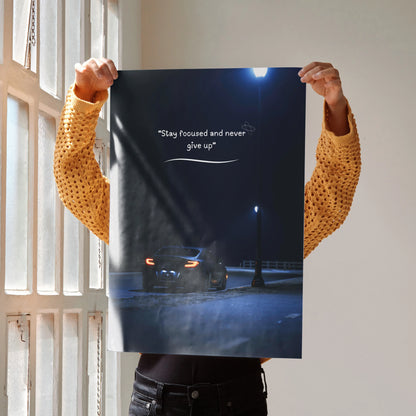 Motivational poster wall art featuring Toyota GR86 in a dark street setting with inspiring text "Stay focused and never give .