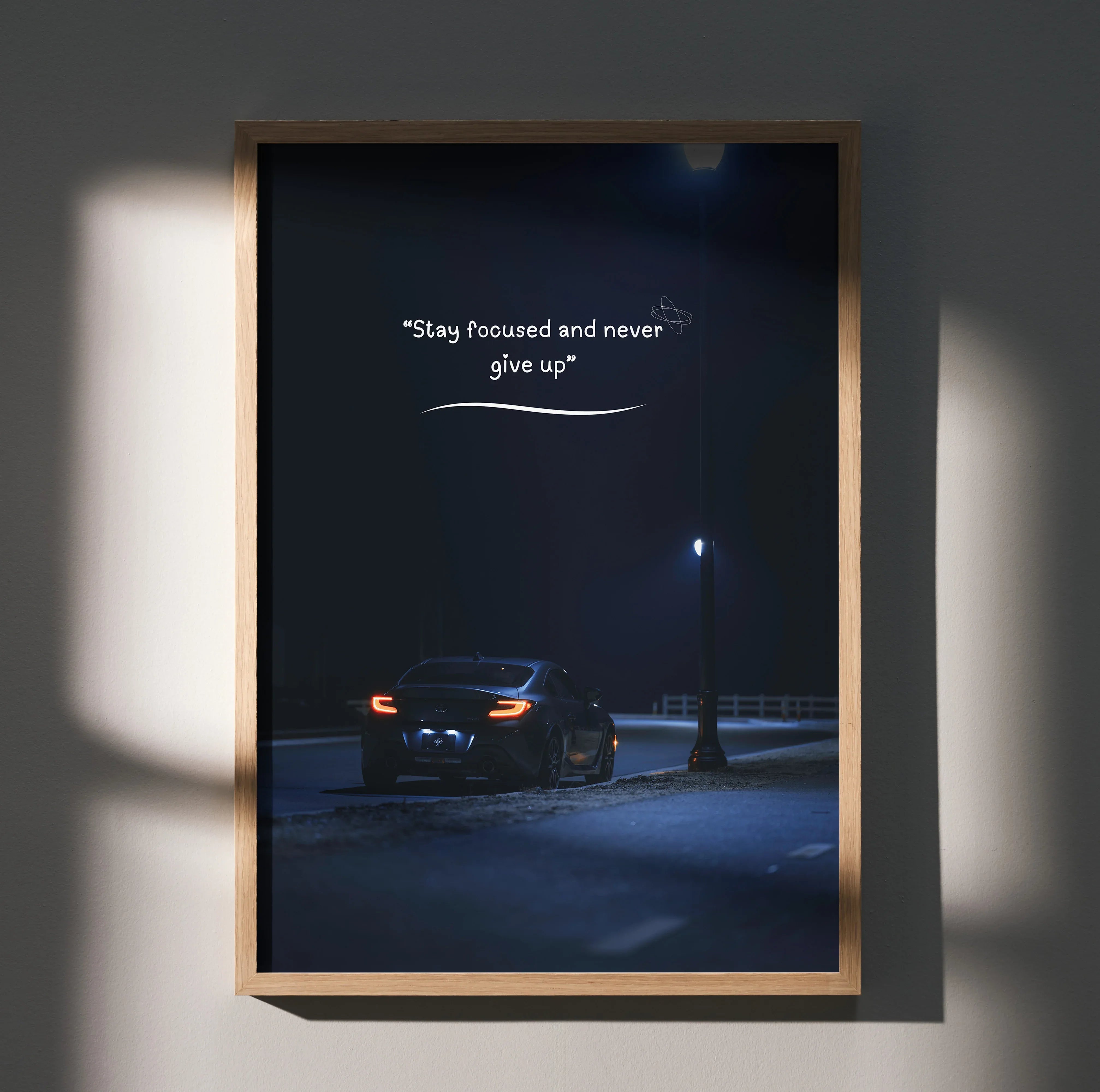 Motivational poster wall art featuring black Toyota GR86 under streetlight with inspiring quote on dark background.