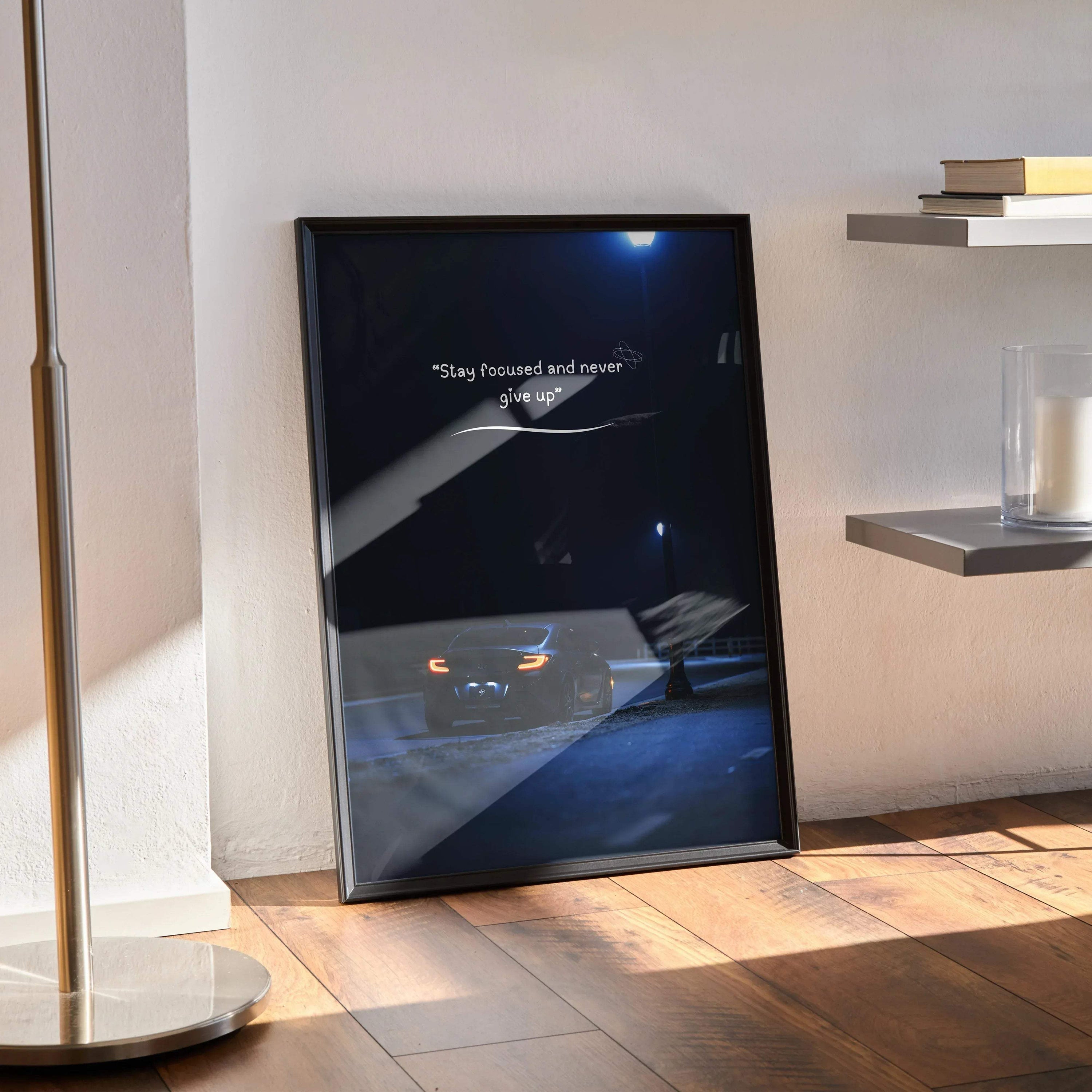 Toyota GR86 motivational poster with inspiring text, black frame wall art on wooden floor.