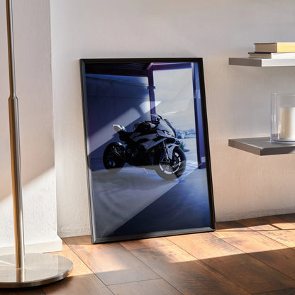 Framed BMW S1000RR poster with sleek motorcycle artwork displayed on sunlit wooden floor wall art.