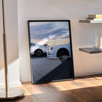 Nissan GTR R34 Skyline close-up poster in black frame leaning against wall on wood floor, automotive wall art.